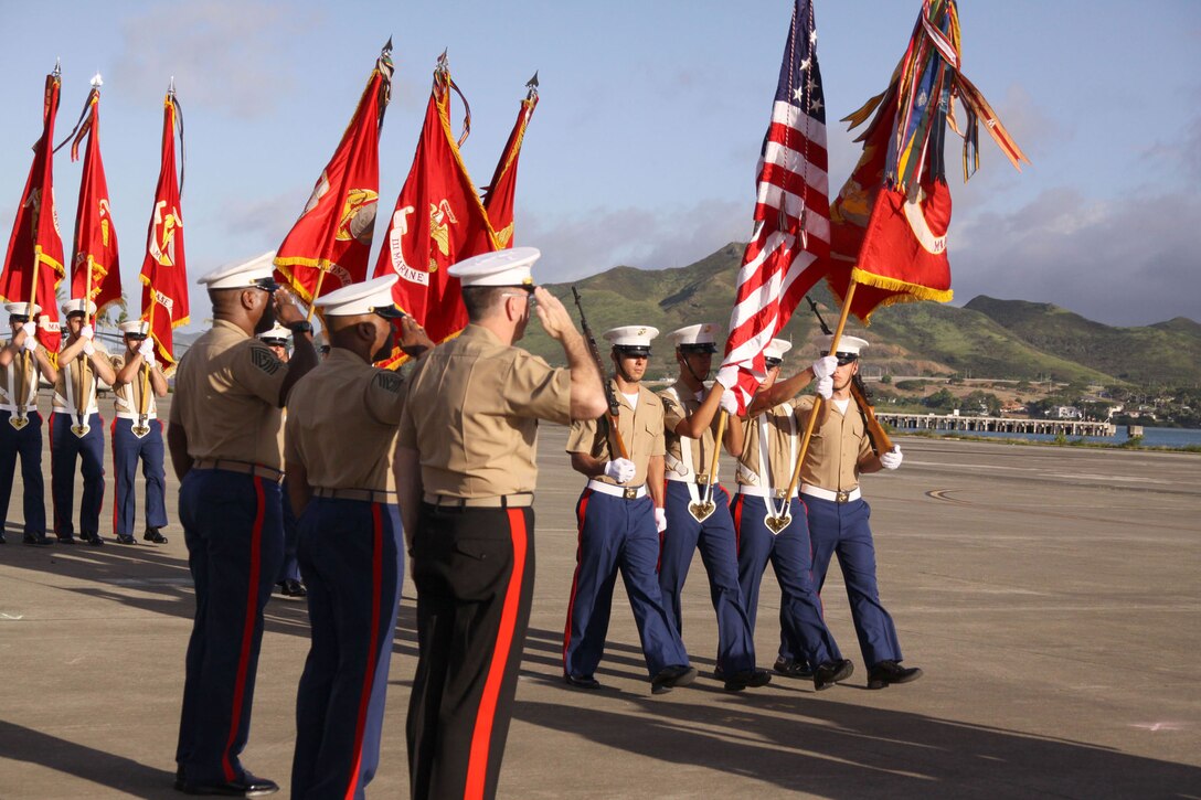 (From left to right) Sgts. Maj. Evans McBride, James Futrell and Lt. Gen. Keith J. Stalder, commanding general, U.S. Marine Corps Forces, Pacific, salute as the colors pass by during the pass in review during the MarForPac sergeant major post and relief and retirement ceremony at the MCBH flightline.