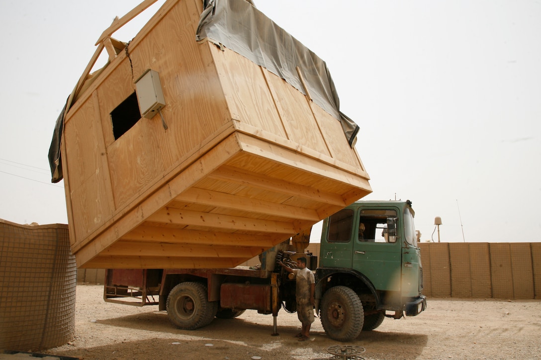 An Iraqi contractor operates a tow crane to remove a building from Combat Outpost Hit, Iraq, as part of the demilitarization of the base, June 17, 2009.  Marines with Company F, 2nd Battalion, 1st Marine Regiment, Regimental Combat Team 8, prepared COP Hit for return to the Government of Iraq as part of the responsible drawdown of U.S. forces.