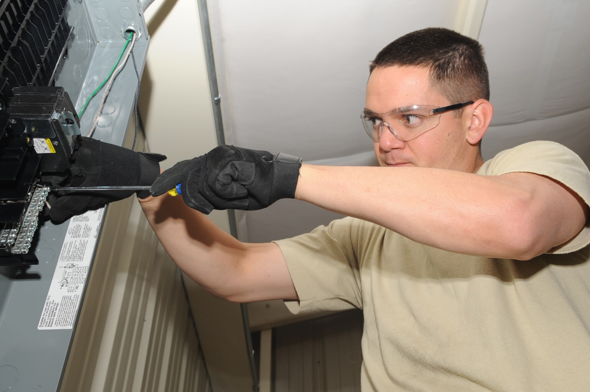 TEAM BUCKLEY WARRIOR OF THE WEEK -- Tech Sgt. Billie Hartman installs wires into a power panel inside bldg. 500 at Camp Rattlesnake June 9. Sergeant Hartman is an electrical systems supervisor from the 460th Civil Engineer Squadron and is Team Buckley's Warrior of the Week for June 12 - 18. (U.S. Air Force photo by Staff Sgt. Sanjay Allen)