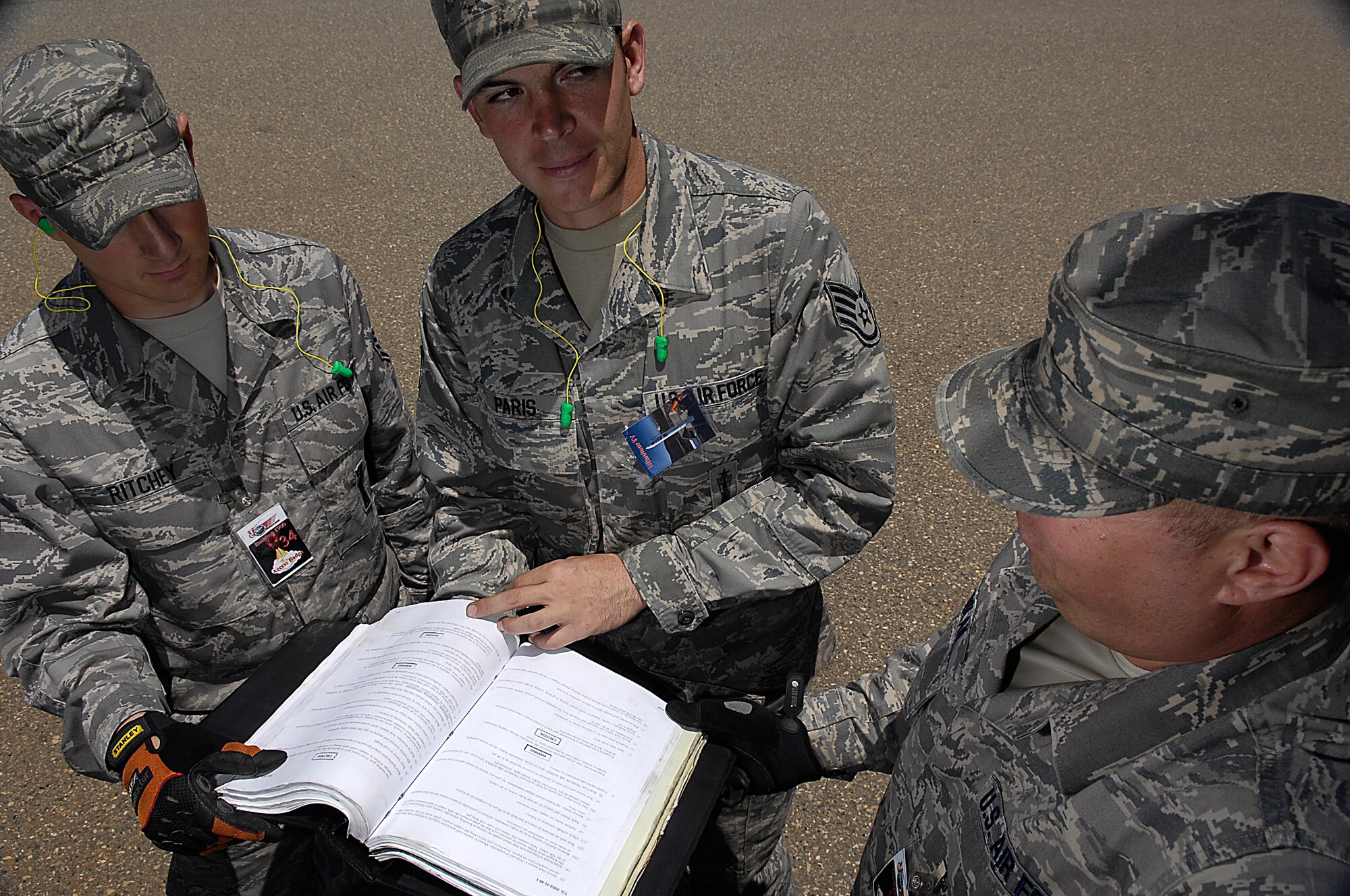 VANDENBERG AIR FORCE BASE, Calif. -  Tech. Sgt. Billy Nolan and Staff Sgts. Neal Paris and Robert Ritchey, all with the 1st Air and Space Test Squadron, go over transportation handling technical orders. The 1st ASTS is the only full-service Air Force organization capable of launch and integration of several launch vehicles.  (U.S. Air Force photo/Staff Sgt. Vanessa Valentine) 