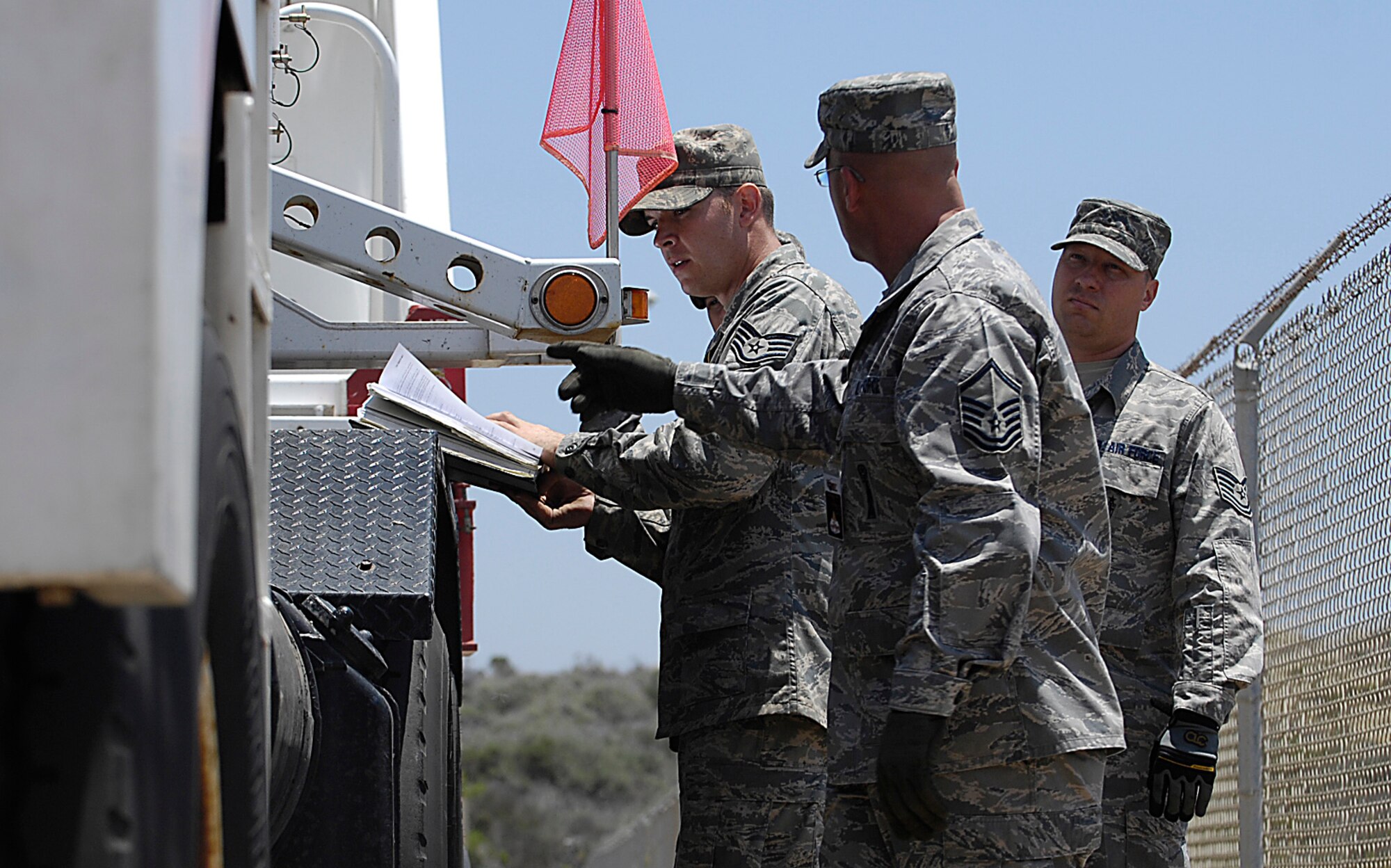 VANDENBERG AIR FORCE BASE, Calif. -  Tech. Sgt. Billy Nolan and Staff Sgts. Neal Paris and Robert Ritchey, all with the 1st Air and Space Test Squadron, go over transportation handling technical orders with their team leader, Master Sgt. David Grimes. The 1st ASTS is the only full-service Air Force organization capable of launch and integration of several launch vehicles.  (U.S. Air Force photo/Staff Sgt. Vanessa Valentine) 