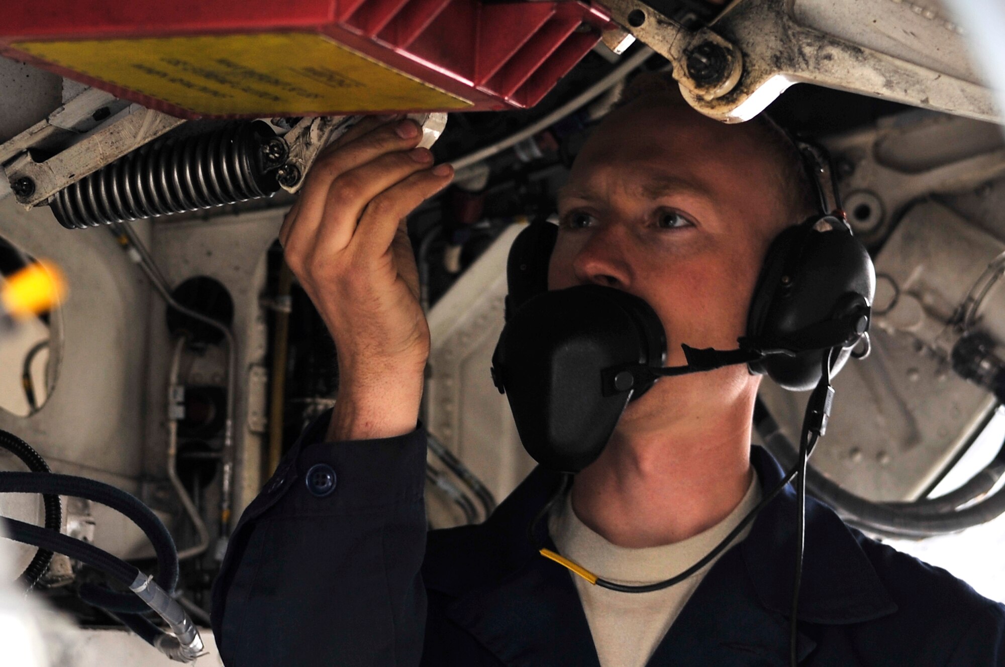 EIELSON AIR FORCE BASE, Alaska -- Staff Sgt. Gerald Ingram adjusts the landing gear up-lock hook on an F-16 Aggressor during NORTHERN EDGE 2009, June 19. NE09 is one in a series of U.S. Pacific Command exercises that prepare joint forces to respond to crises in the region. Sergeant Harvey is a crew chief assigned to the 18th Aircraft Maintenance Unit. (U.S. Air Force photo/Staff Sgt. Christopher Boitz)