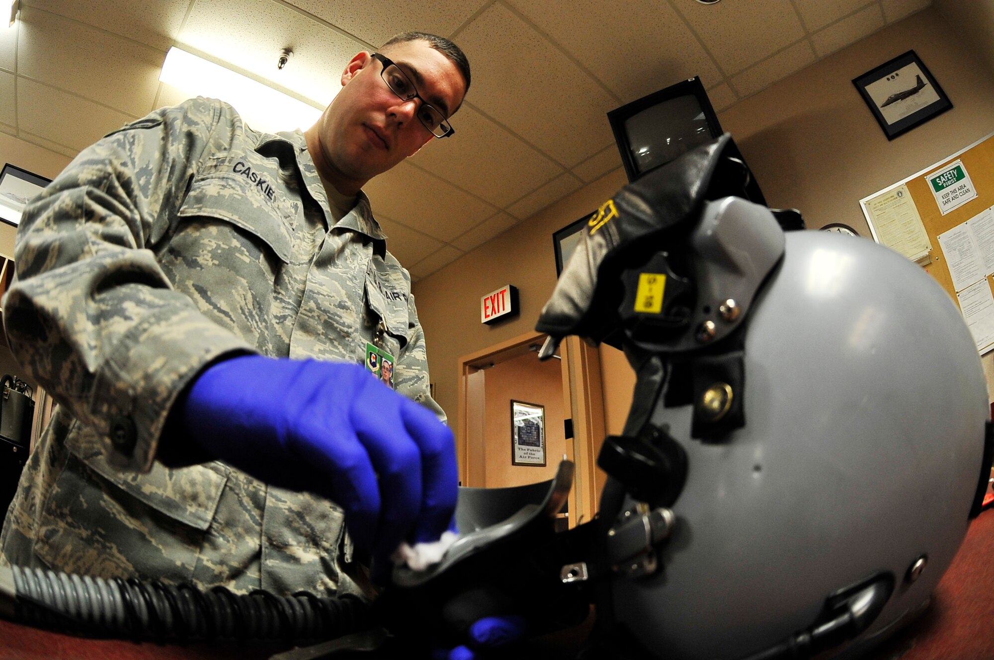 EIELSON AIR FORCE BASE, Alaska -- Airman 1st Class Brian Caskie cleans the inside of a Joint Helmet Mounted Cueing System during NORTHERN EDGE 2009, June 19. The JHMCS helmet enables pilots to accurately cue onboard weapons against enemy aircraft. Airman Caskie is an aircrew flight equipment technician assigned to the 35th Operations Support Squadron from Misawa Air Base, Japan. (U.S. Air Force photo/Staff Sgt. Christopher Boitz)