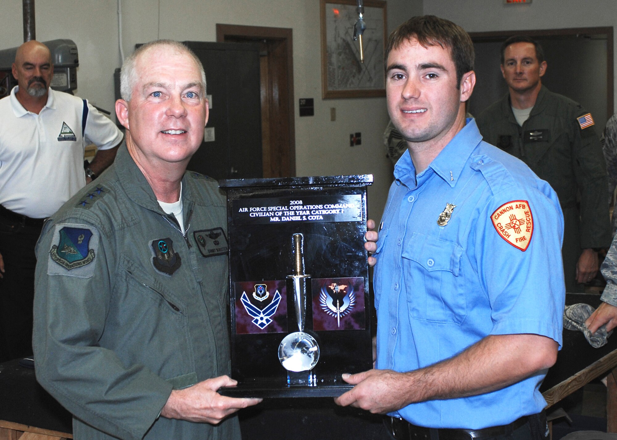 CANNON AIR FORCE BASE, N.M. -- Lt. Gen. Donald Wurster, Commander, Air Force Special Operations Command, presents  Daniel Cota, 27th Special Operations Civil Engineer Squadron, with the 2008 Air Force Special Operations Command Civilian of the Year Category 1 Award June 19. Mr. Cota is a firefighter for the base. (U.S. Air Force photo by Airman 1st Class Danielle Powell)