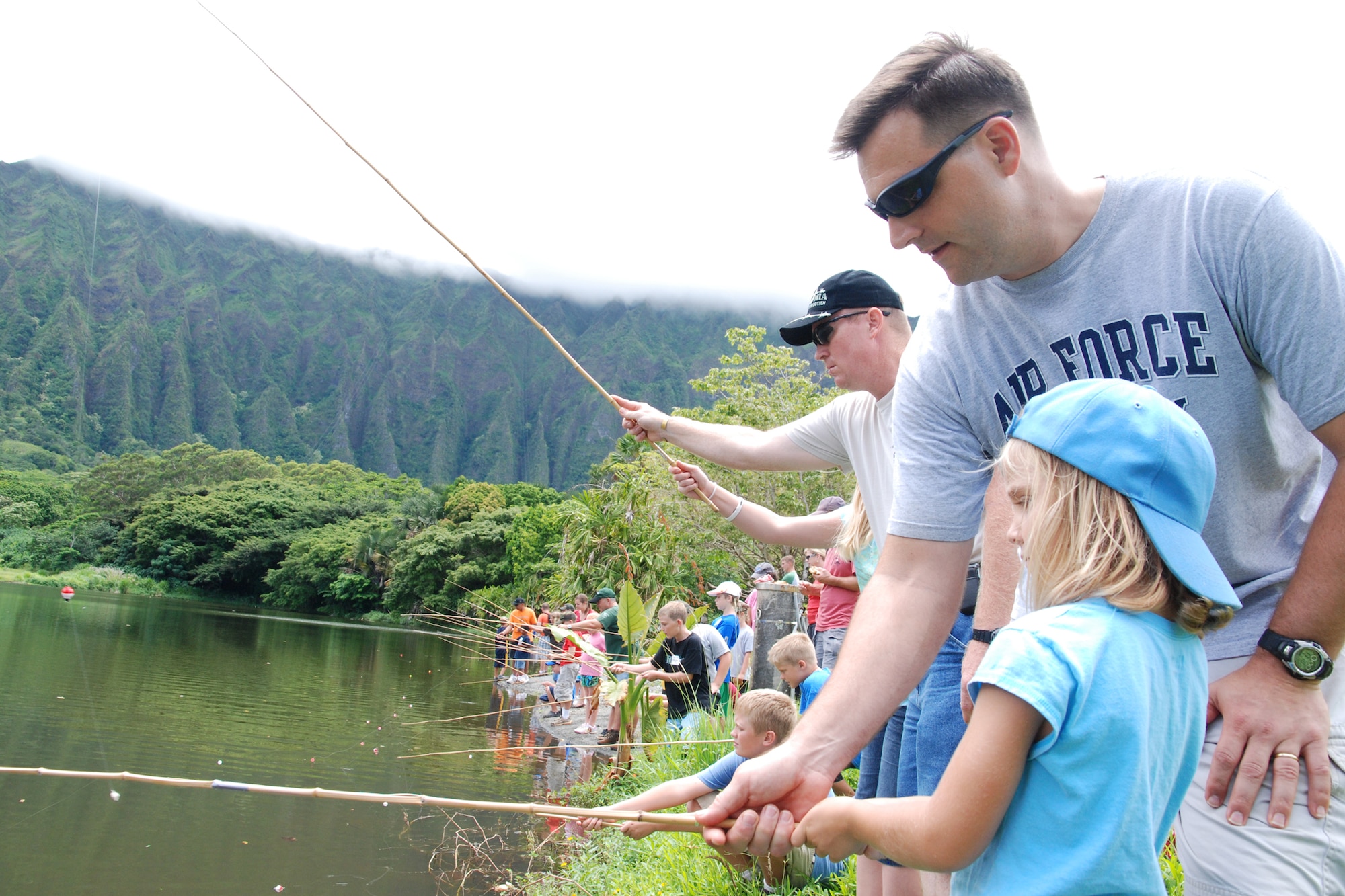 KANEOHE, Hawaii -- Faith Dalfonso, and her father Lt.Col. Ken Dalfonso, Pacific Air Forces Headquarters Security Forces deputy commander, stand at lakeside fishing during the 10th Annual Keiki Fishing Tournament June 10 at the Ho'omaluhia Botanical Gardens. More than 170 children and their families were treated to lunch and a Polynesian Culture Center demonstration before the fishing tournament began. The keiki caught a record-setting 449 fish at the tenth annual tournament. (U.S. Air Force photo/Staff Sgt. Mike Meares) 
