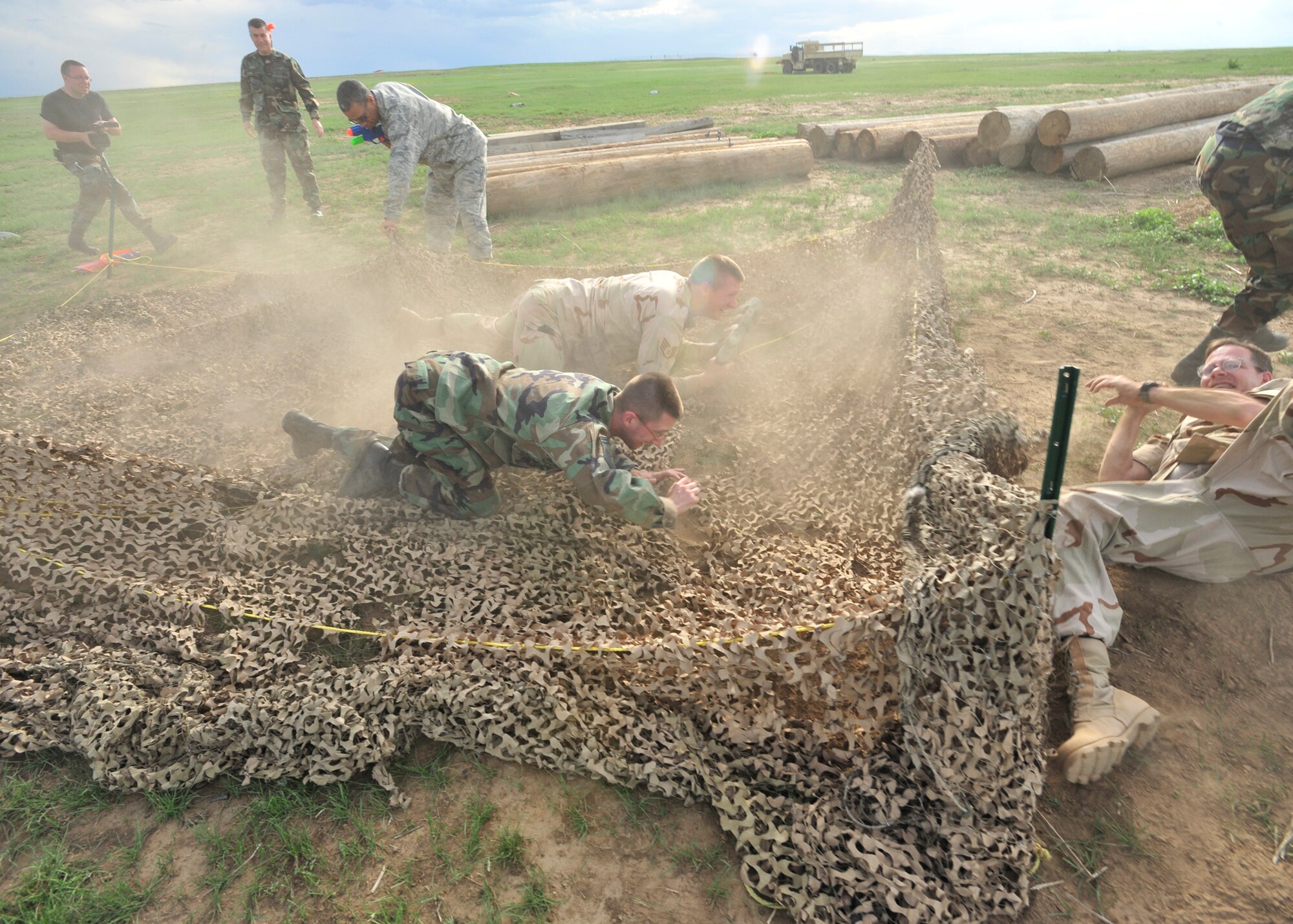 BUCKLEY AIR FORCE BASE, Colo. -- Airmen crawl through a portion of the obstacle course at Buckley’s Combat Dining-in May 29 at Camp Rattlesnake here. More than 100 people showed up for the event. (U.S. Air Force photo by Senior Airman Alex Gochnour)