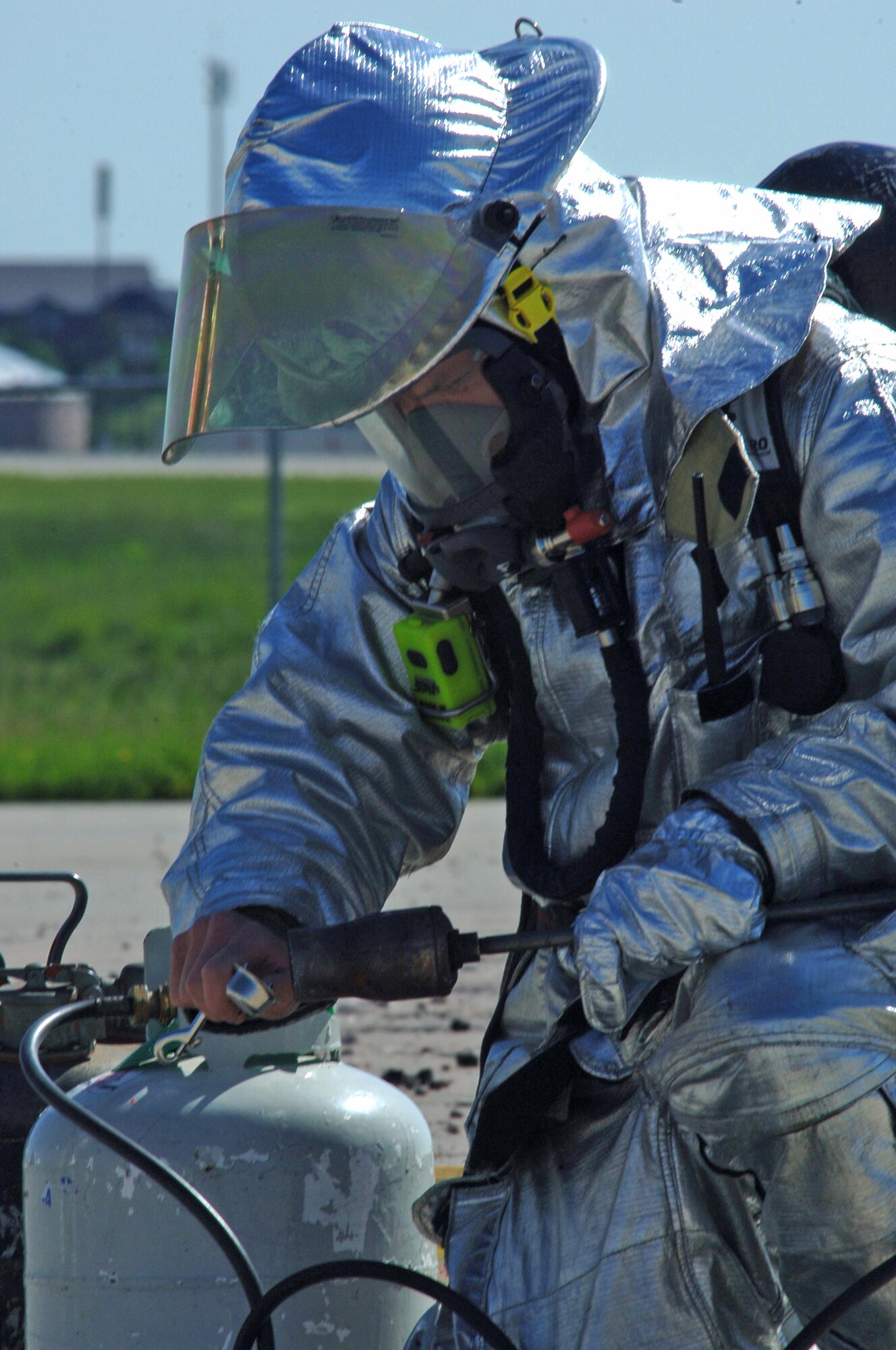 Senior Airman Ryan Logan, 28th Civil Engineer Squadron firefighter, sparks a propane torch during a pit fire here, June 19.  Ellsworth firefighters use pit fires to train new Airmen and Department of Defense civilian firefighters.  Pit fires are also used as refresher training for all 28th Bomb Wing firefighters. (U.S. Air Force photo/Senior Airman Anthony Sanchelli)