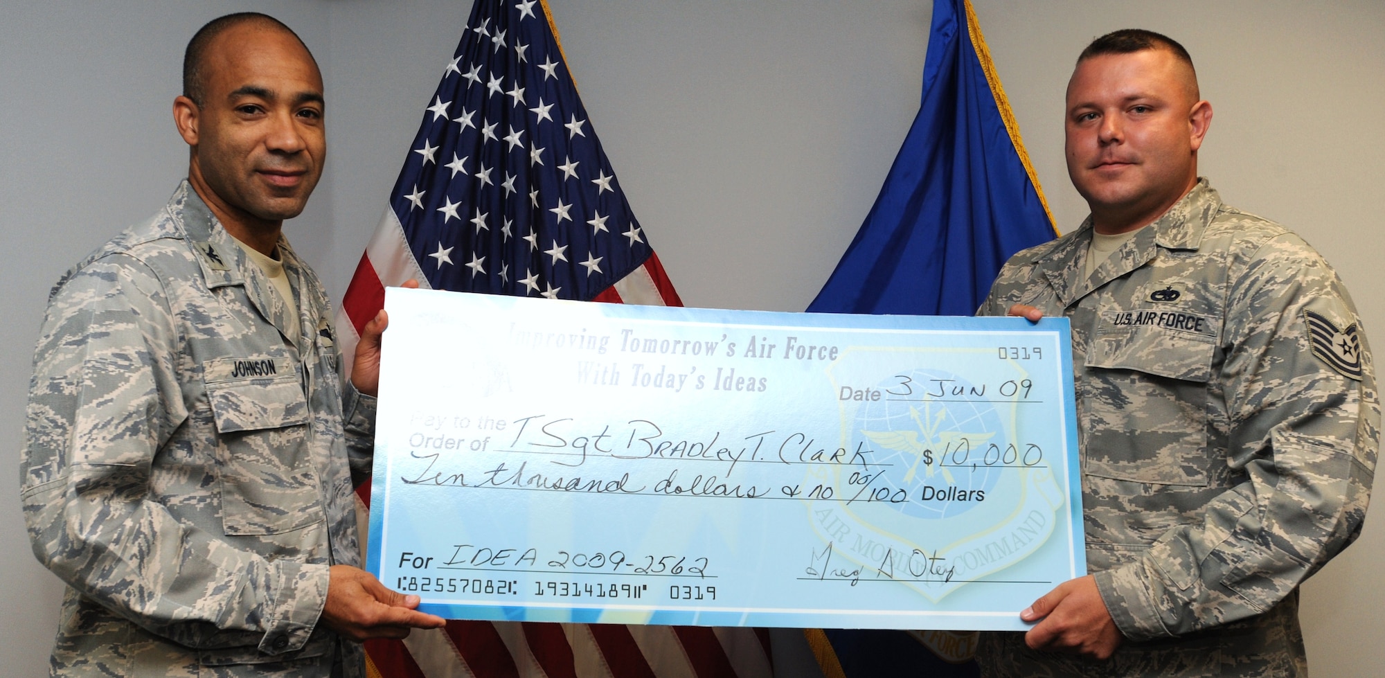 Col. James Johnson, former 19th Airlift Wing vice commander, presents a check for $10,000 to Tech. Sgt. Brad Clark, 19th Component Maintenance Squadron jet engine intermediate maintenance supervisor, at Bldg. 1250 June 10, for his accepted idea submission to the IDEA program. Clark’s idea involved replacing pump housing inserts on a C-130 propeller without taking it off the plane, which expedited maintenance procedures and annually saves approximately $410,000. (U.S. Air Force Photo by Senior Airman Christine Clark)