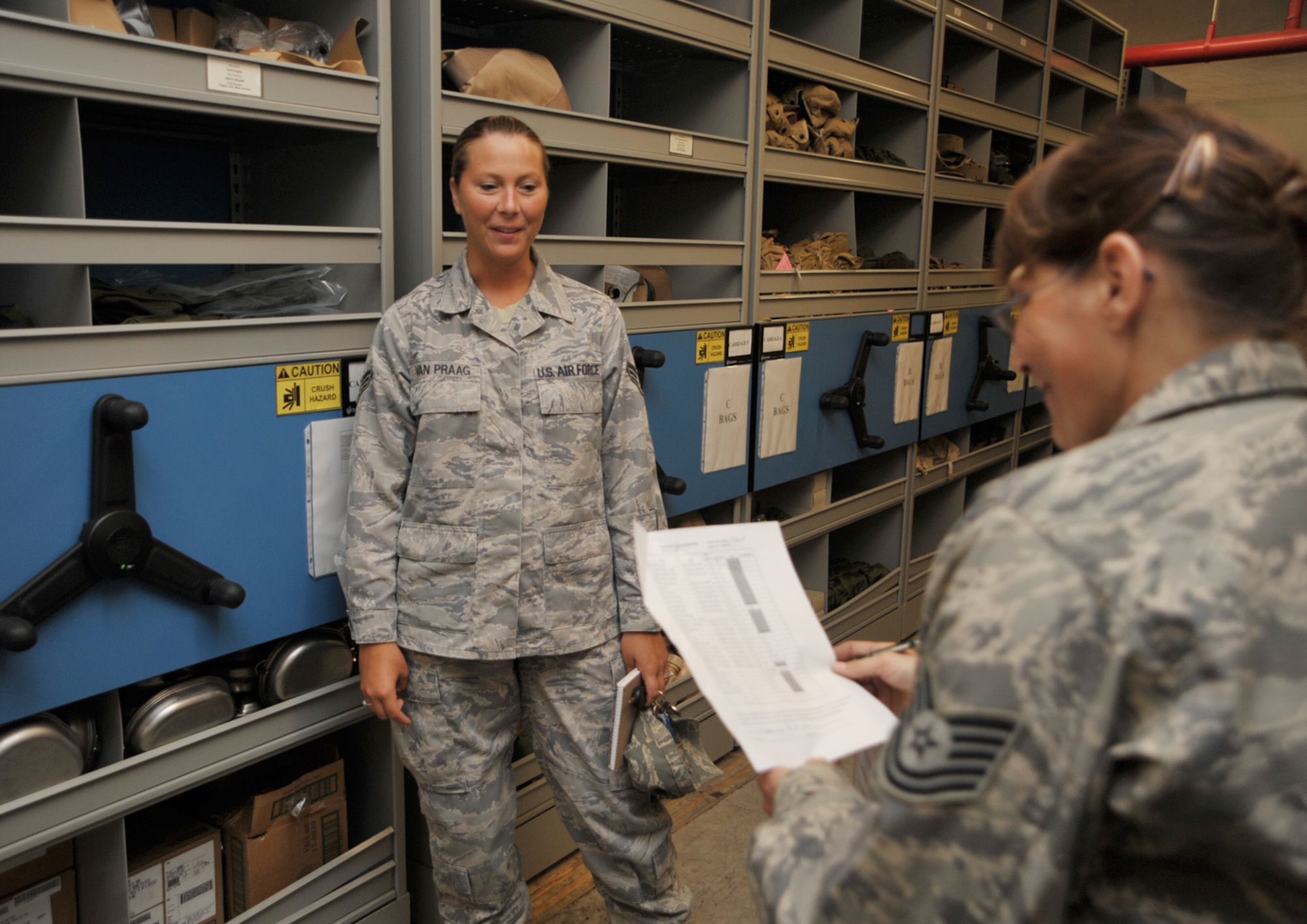 Senior Airman Carrie Van Praag talks talks about supply issues with Tech. Sgt. Tina Koehn during the 931st Air Refueling Group's drill weekend in June. Airman Van Praag is the 931st's new supply specialist. Sergeant Koehn is the supply noncommissioned-officer-in-charge for the 931st Civil Engineer Squadron. (U.S. Air Force photo/Tech. Sgt. Jason Schaap) 