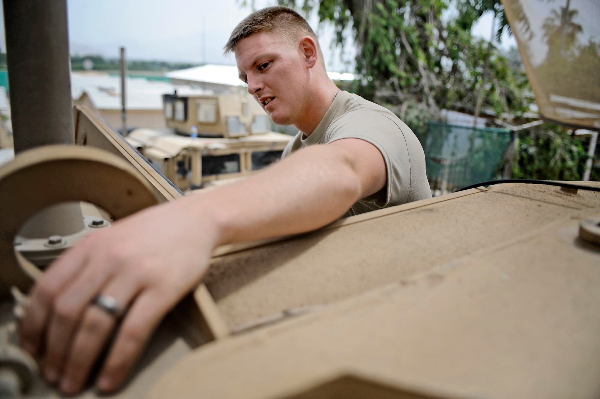 Staff Sgt. Andrew Palmer, Nangarhar Provincial Reconstruction Team telephone maintenance specialist, performs routine maintenance on a mine-resistant, ambush-protected vehicle May 30 at Forward Operating Base Fenley-Shields, Afghanistan. The PRT is responsible for development and reconstruction projects in Nangarhar Province. The projects are built by local contractors and are designed to improve the livelihood of the people living in the area. (U.S. Air Force photo/Staff. Sgt. Shawn Weismiller)