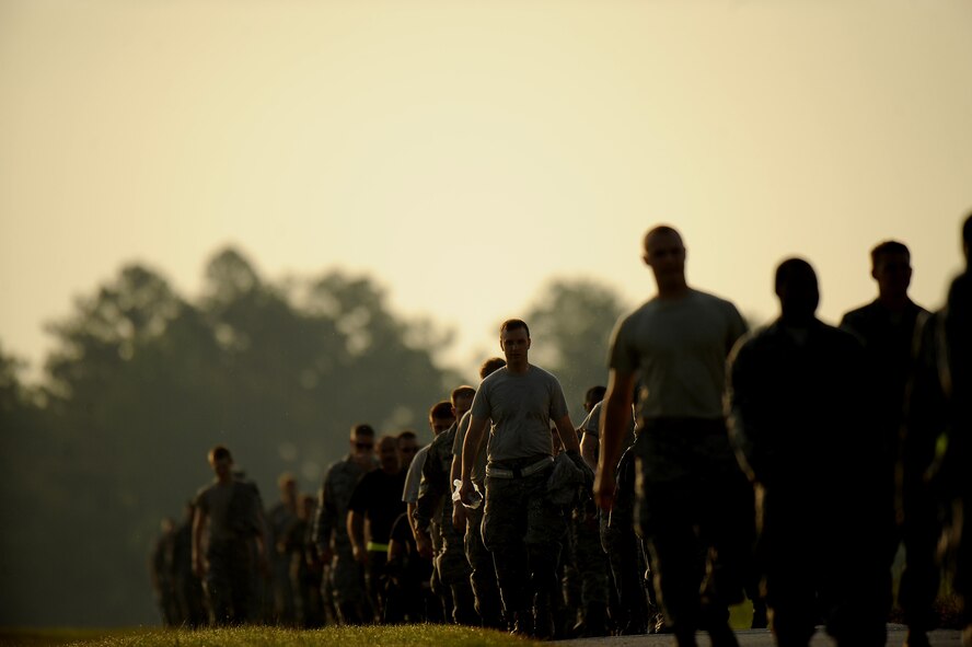MOODY AIR FORCE BASE, Ga. -- Airmen from numerous squadrons around the base walk back to the starting point after a foreign object debris walk here June 19. Hundreds of Airmen walked side by side to clear the flightline of any debris that could cause damage to aircraft. (U.S. Air Force photo by Senior Airman Gina Chiaverotti)
