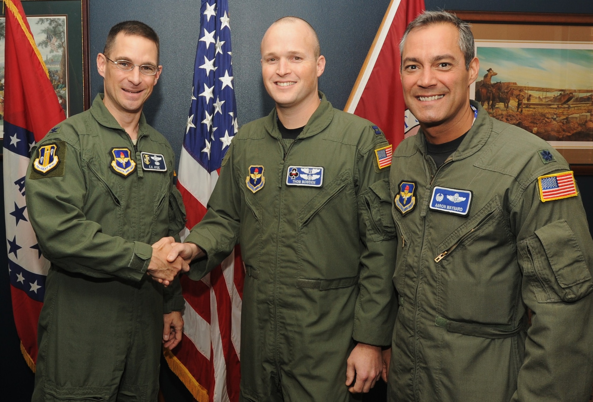Col. C.K. Hyde, 314th Airlift Wing commander, and Lt. Col. Aaron Maynard, 62nd Airlift Squadron commander, presents Capt. Thomas Bowden, 62nd Airlift Squadron flight surgeon, with a coin for being selected to be the next Air Force Thunderbirds flight surgeon May 20, 2009. While holding this position he will be traveling with the Ambassadors in Blue for the next two years. The Air Force Thunderbirds are located at Nellis Air Force Base, Nev. (U.S. Air Force Photo by Airman 1st Class Ethan Morgan)