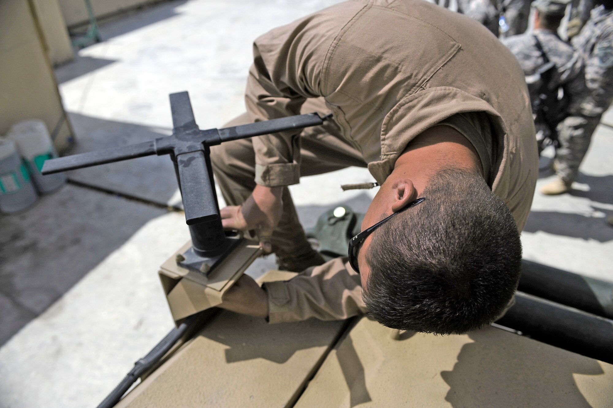 Staff Sgt. Josh Newman, Nangarhar Provincial Reconstruction team satellite systems specialist, performs routine maintenance on a mine-resistant, ambush-protected vehicle May 30 at Forward Operating Base Fenley-Shields, Afghanistan. The PRT is responsible for development and reconstruction projects in Nangarhar Province. The projects are built by local contractors and are designed to improve the livelihood of the people living in the area. (U.S. Air Force photo/Staff. Sgt. Shawn Weismiller)