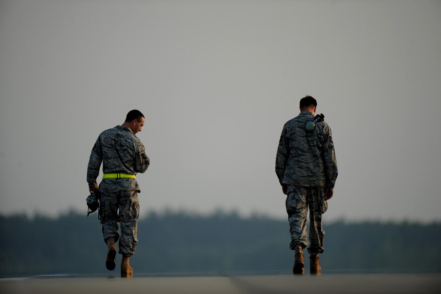 MOODY AIR FORCE BASE, Ga. -- Moody Airmen look for objects on the flightline during a foreign object debris walk here June 19. The purpose of a FOD walk is to remove objects from the flightline that can cause serious damage to military aircraft. (U.S. Air Force photo by Senior Airman Gina Chiaverotti)