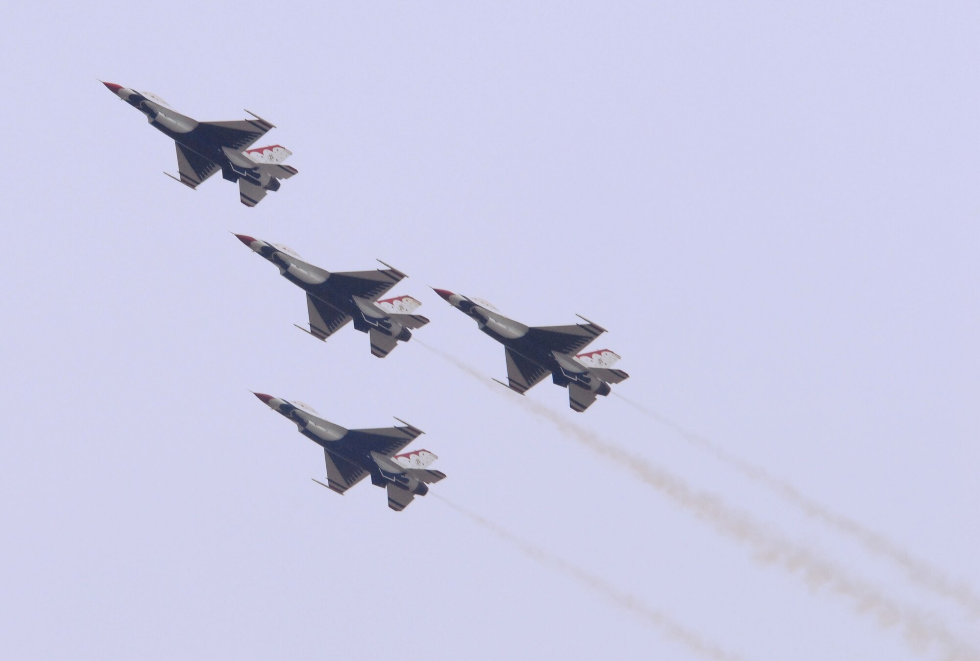 An Arrowhead formation of four U.S. Air Force Thunderbird F-16 Falcons soars in the sky above Dover Air Force Base during the opening day of their Open House and Air Show June 19. Shortly after, the formation performed a ‘Arrowhead Loop’ maneuver where all four jets simultaneously looped in mid air. (U.S. Air Force photo/Tech. Sgt. Kevin Wallace)
