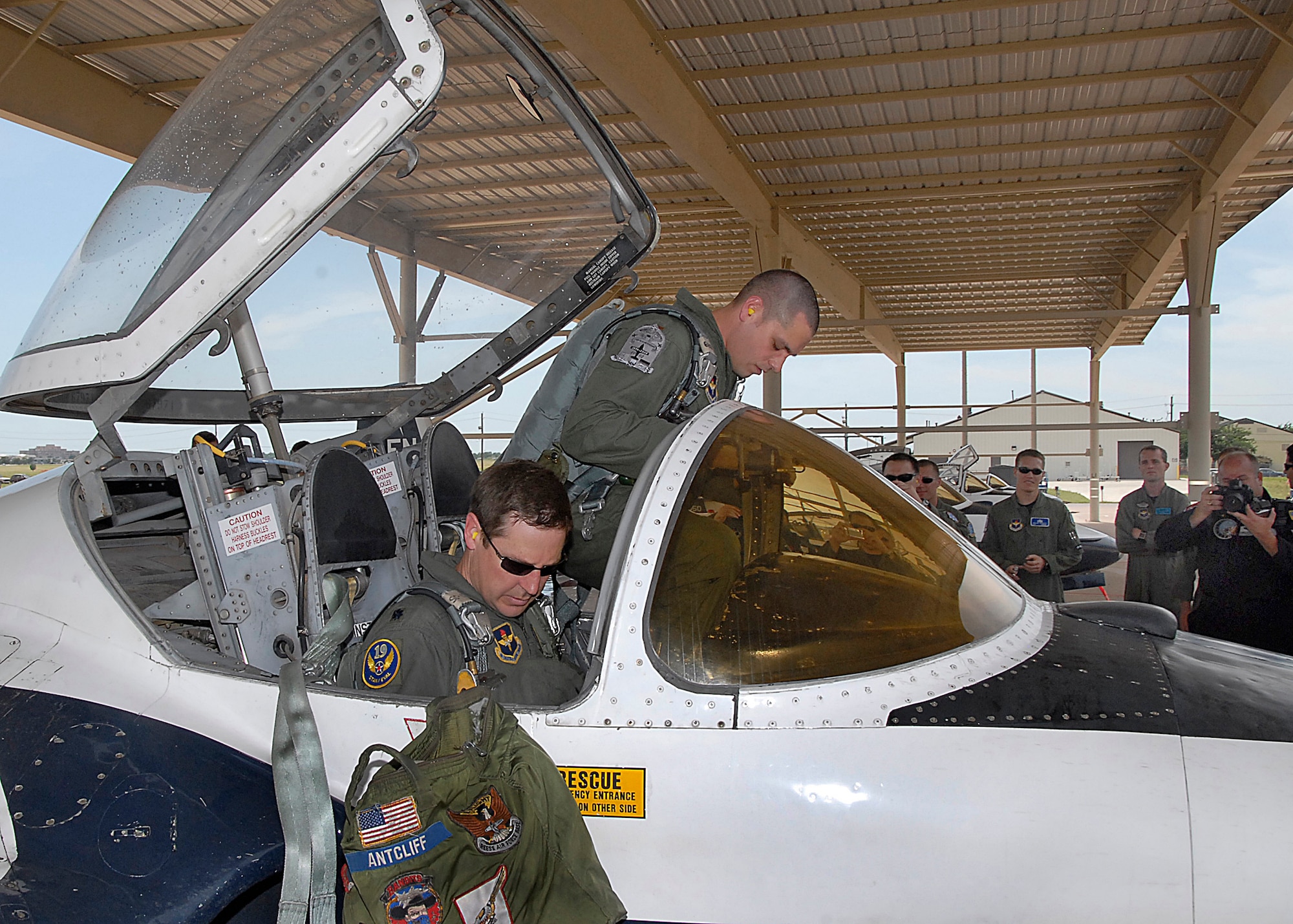 Lt. Col. Doug Antcliff and 2nd Lt. Trevor Kernes prepare to egress a T-37B Tweet June 17 at Sheppard Air Force Base, Texas, marking the end of the aircraft's more than 50-year service to the Air Force. More than 78,000 Air Force pilots have trained in the Tweet since 1959. Colonel Antcliff is a 19th Air Force standards and evaluation pilot. Lieutenant Kernes is a student pilot. (U.S. Air Force photo/Harry Tonemah)