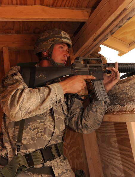 Airman 1st Class Jeremiah Parish, 49th Civil Engineer Squadron, performs security during a simulated ground attack on the Civil Engineer Pit, June 18, at Holloman Air Force Base, N.M., during exercise Coronet Gold Rush 09-06. He keeps a watchful eye on the front gate where opposing forces tried to gain access to base through a simulated fire fight. (U.S. Air Force photo/Airman 1st Class Sondra Escutia)