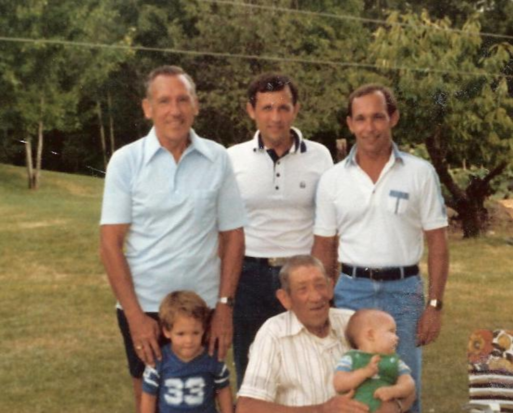 Lt. Col. (retired) Robert  Hansen, standing left, is director of Joint Base McGuire Dix-Lakehurst, N.J.'s Retiree activitees Office. Colonel Hansen says his late father, Rueben Hansen, seated next to great-grandson Ryan, and holding great-grandson Ryan, passed on several enduring values. Standing next to Colonel Hansen in this 1981 photo are his sons, Robert Hansen and Richard Hansen, both retired Air Force officers.  "As I look way back in my life," Colonel Hansen said. "I have two distinct memories of lessons learned from my Dad, Rueben W. Hansen, (1896-1983.) The first is discipline. In his low key way, he demonstrated his approach to discipline by personal actions. Make sure you get the job done and done right. No short cuts, and don’t be afraid of a little hard work. I always knew it when I didn’t follow his expectations. His discipline was not overt, but rather it was subtle and lasting. He expected you to be honest and trustworthy, because that is the way he lived his life. The second is learning how to get the most out of nature by growing crops. He was a farmer at heart and lived some of his life as a farmer. He taught me how to plant, cultivate and harvest, so that we would have fresh food on our table. I grew up as the keeper of the large garden we always had. Since retirement from active duty, I have always had a large garden growing in my back yard. Dad’s personal actions have been remembered throughout my active duty career and in retirement. His influence has greatly helped me in achieving my goals. (Courtesy photo)