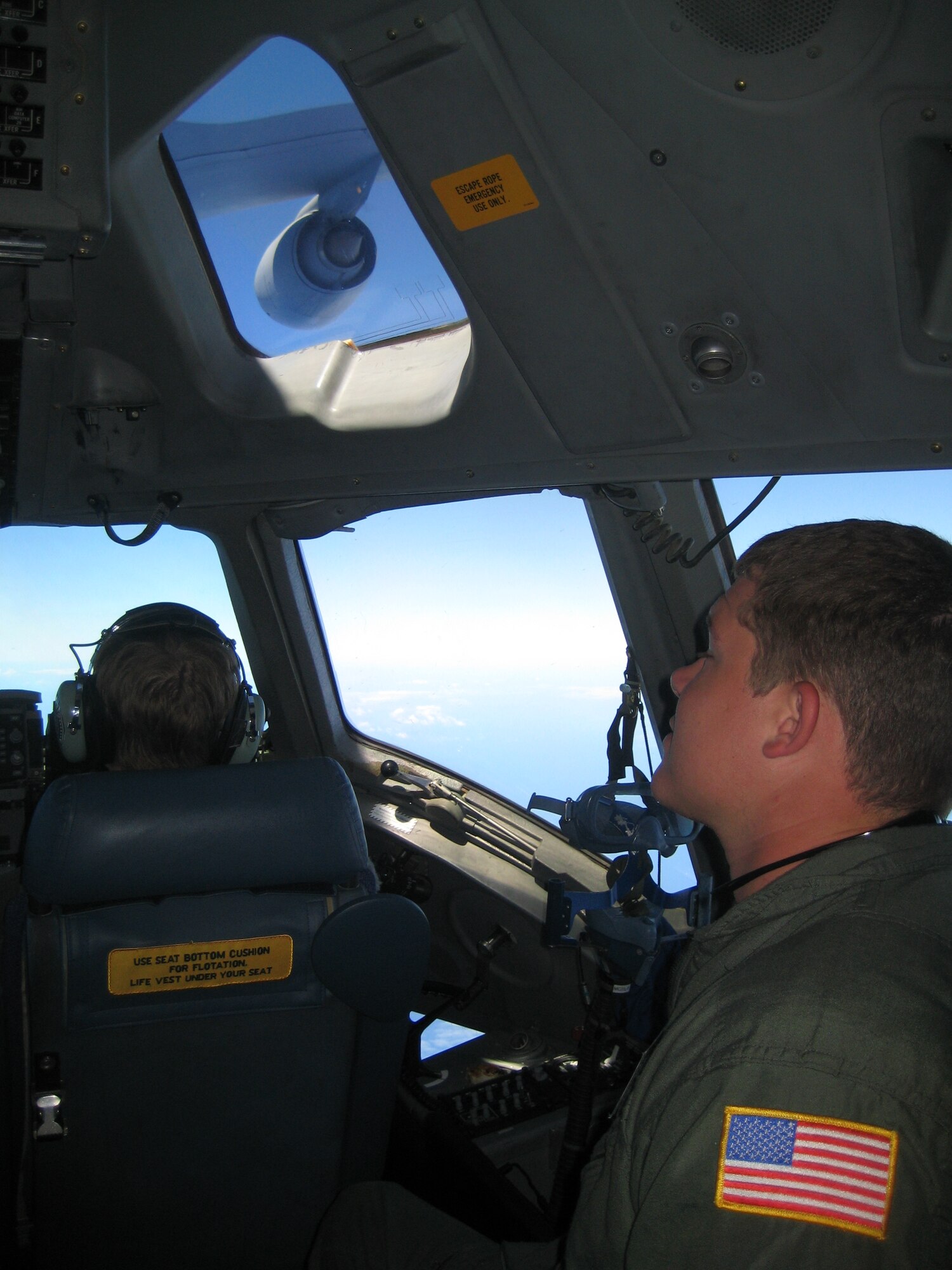 Cadet Second Class Anthony Morosco watches aerial refueling from the cockpit of a C-17 Globemaster III, on a mission from McChord to Hickam Air Force Base, Hawaii June 12. (U.S. Air Force photo/1st Lt. Joseph Wingard)