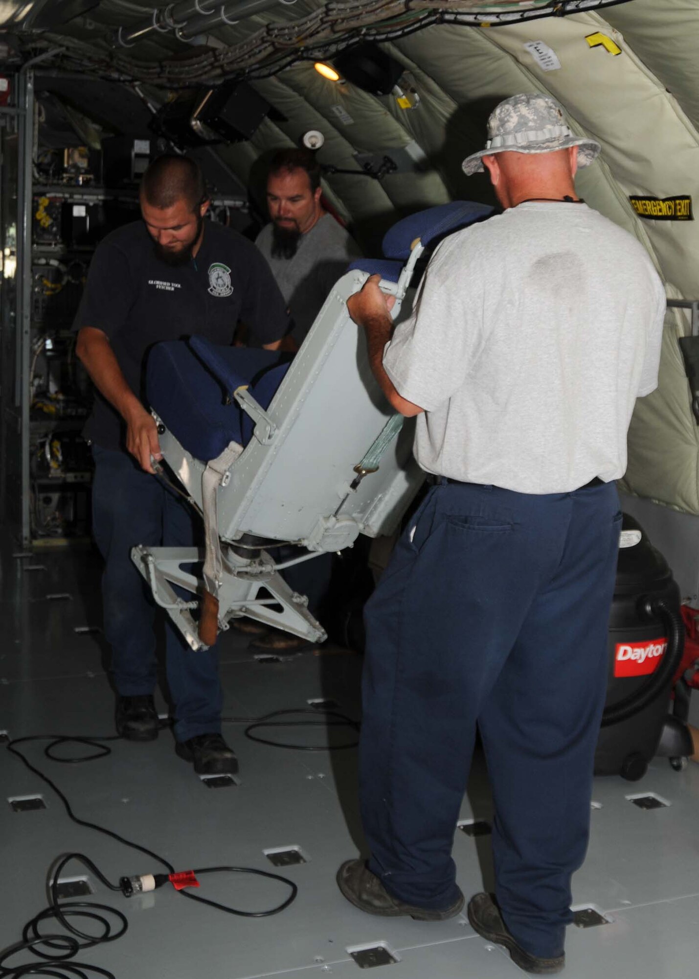 ALTUS AIR FORCE BASE, Okla. — Members of the A-TEAM move chairs from the cockpit of a KC-135 Stratotanker to install carpeting on the floor of the aircraft. This maintenance is being done as part of preparation for the 2009 Air Mobility Command Rodeo at McChord Air Force Base, Wash. in July. (U.S. Air Force photo/Airman 1st Class Tiffany M. Deuel)