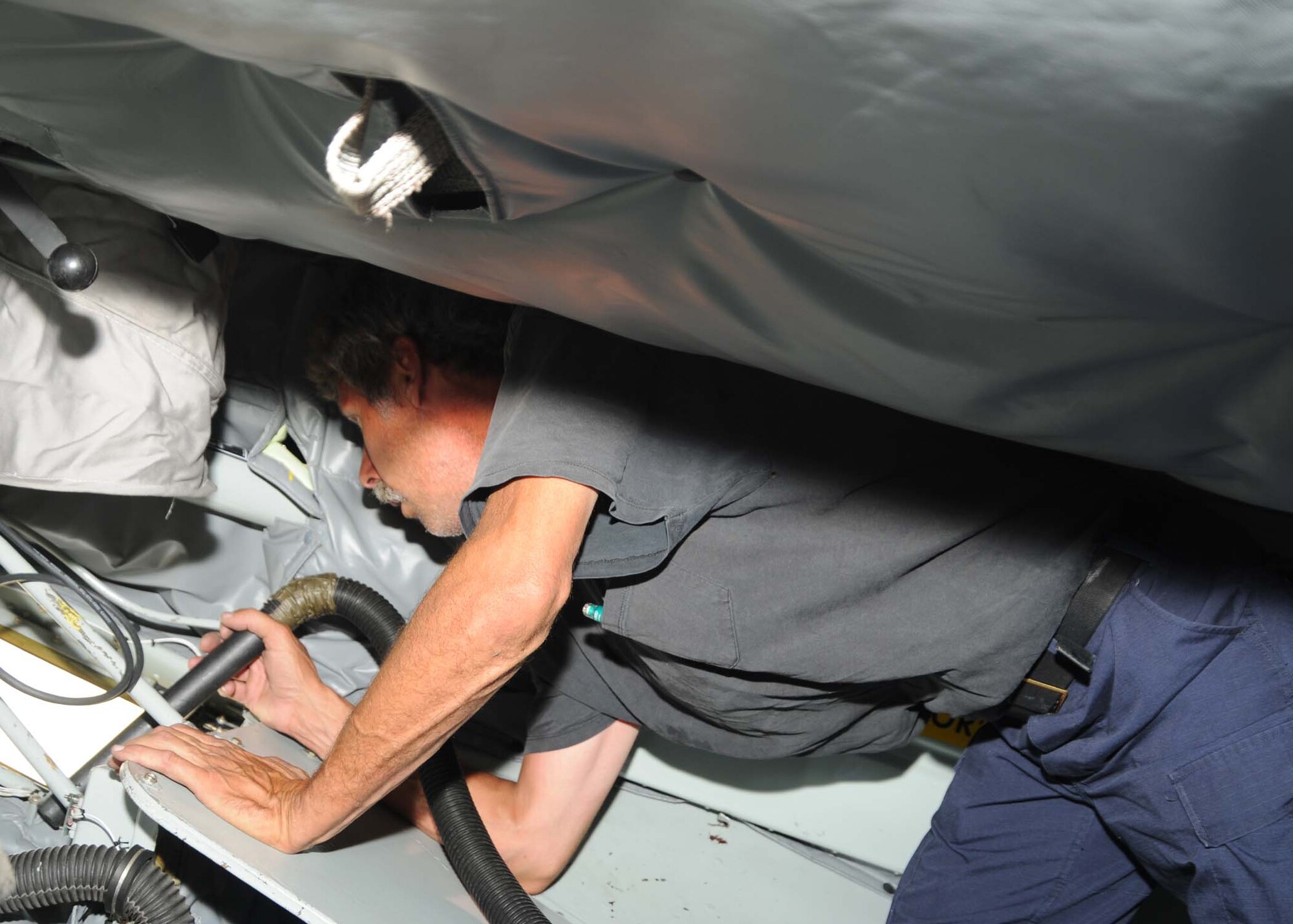 ALTUS AIR FORCE BASE, Okla. — Jim Domian, a member of the A-TEAM, vacuums the boom pod of a KC-135 Stratotanker  in preparation for the 2009 Air Mobility Command Rodeo. During the rodeo competition, the A-TEAM gets inspected on the conditions and maintenance of the aircraft. (U.S. Air Force photo/Airman 1st Class Tiffany M. Deuel)