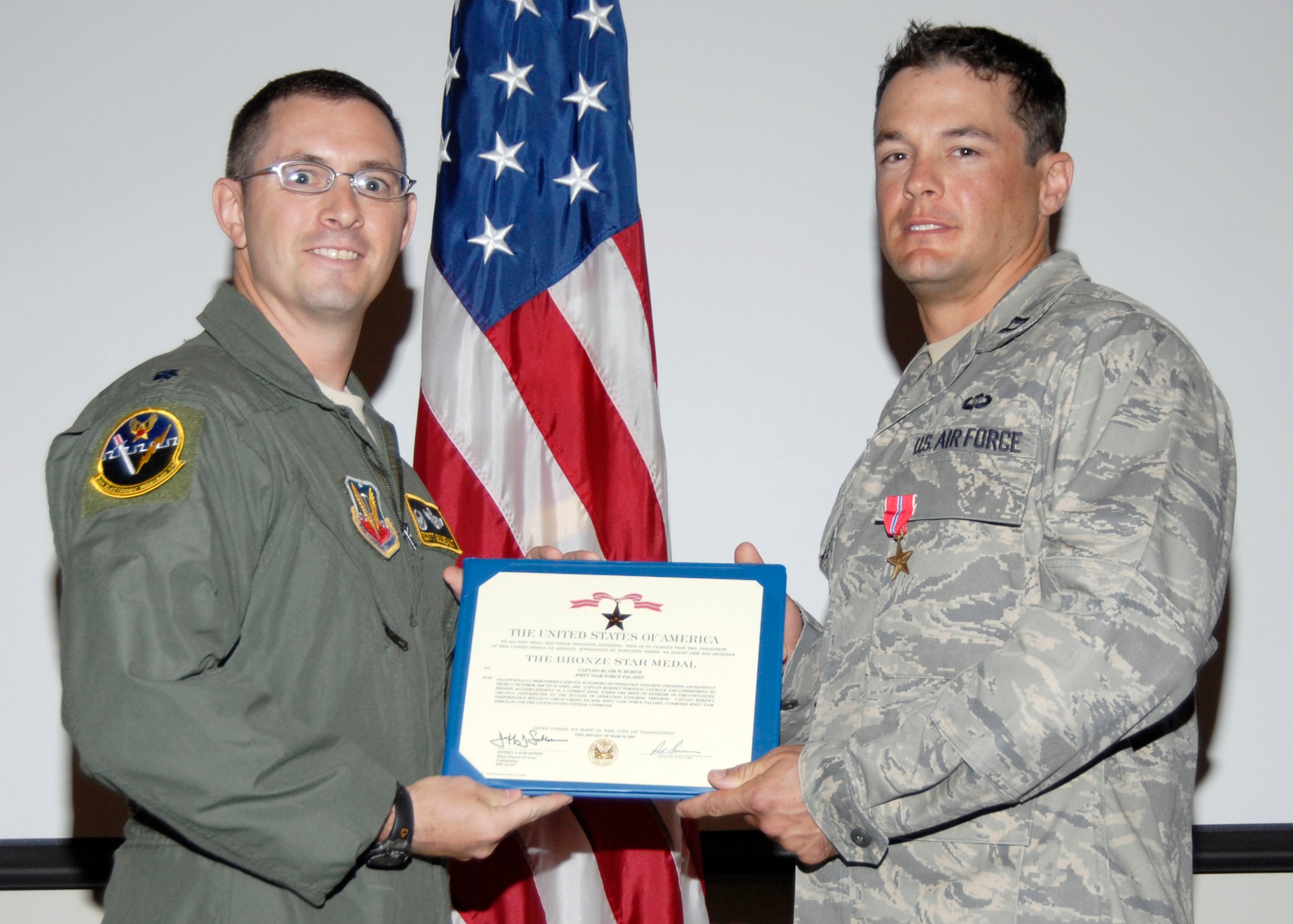 Lt. Col. Scott Guilbeault, 16th Electronic Warfare Squadron commander awards Capt. Blair Byrem with a Bronze Star Medal June 12 in the 53rd Weapons Evaluation Group auditorium. Captain Byrem earned his Bronze Star for his meritorious efforts during a six-month deployment to a Forward Operating Base near Bagram Airfield, Afghanistan in support of Operation Enduring Freedom. (U.S. Air Force photo/Robin Walters)