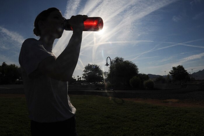 U.S. Air Force 2nd Lt. Sarah Kline a vehicle management and analyst officer assigned to the 99th Logistics and Readiness Squadron drinks water during physical training at Nellis Air Force Base, Nev.      (U.S. Air Force Photo/Senior Airman Brian Ybarbo, released)