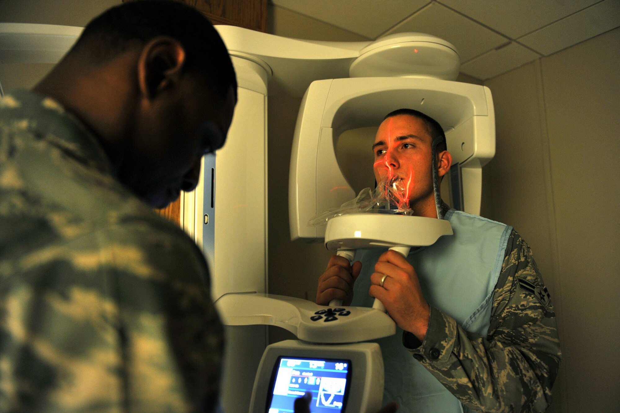 OFFUTT AIR FORCE Neb,.-- Staff Sgt. James Sheard, 55th Medical Group, takes a panoramic x-ray of Airman 1st Class Kyle Reed, also with the 55th MDG, inside the dental facility at the Ehrling Bergquist Clinic here April 26. The 55th MDG scored an outstanding rating on their recent Health Services Inspection becoming the first unit in the continental United States to do so this year. U.S. Air Force Photo by Charles Haymond

