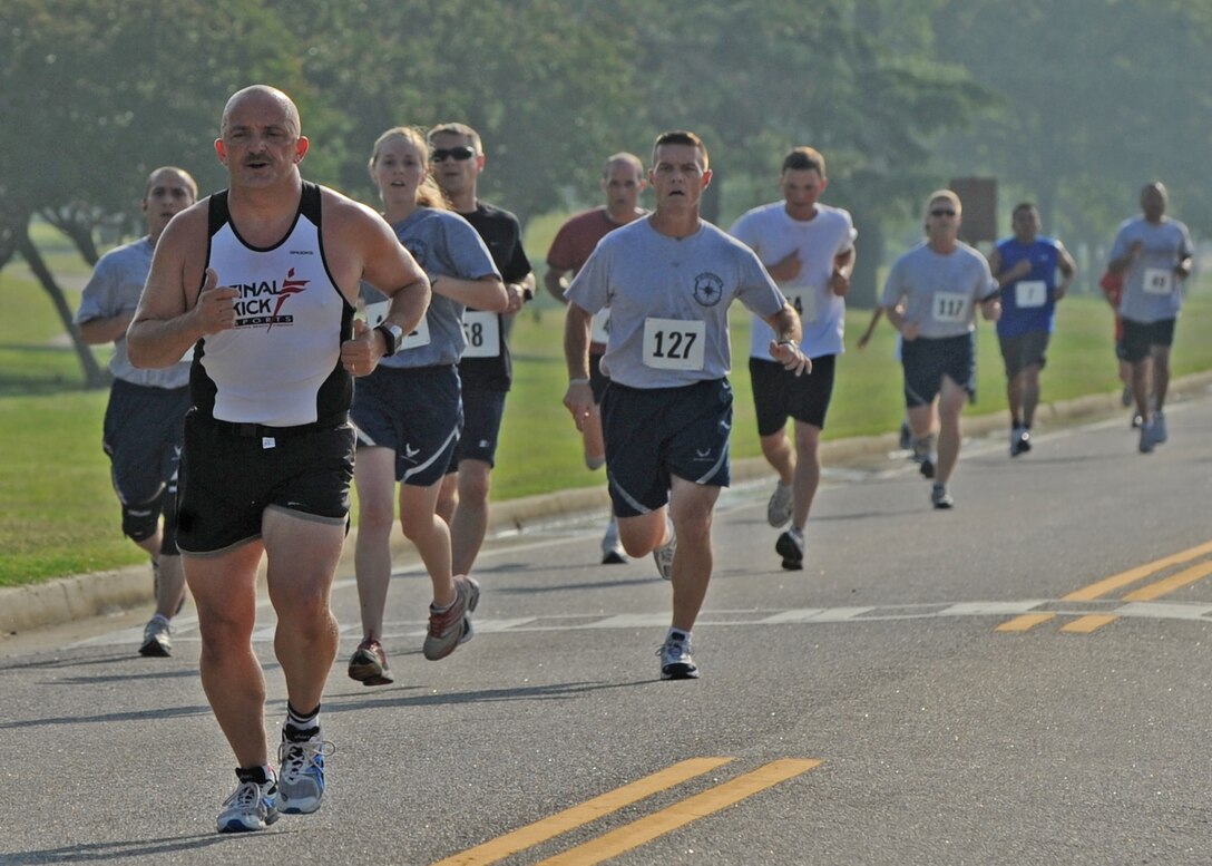 LANGLEY AIR FORCE BASE Va. -- Langley personnel keep a steady pace during the 2009 Langley Chief's Group Annual Spring Fun Run here June 19.  More than 150 runners participated in the 5K.  The Chief's Group will use the proceeds to fund professional military education programs such as Airman Leadership School, First Term Airman Center and Non-commissioned Officer Academy graduation ceremonies. (U.S. Air Force photo/Airman 1st Class Jonathan Koob)