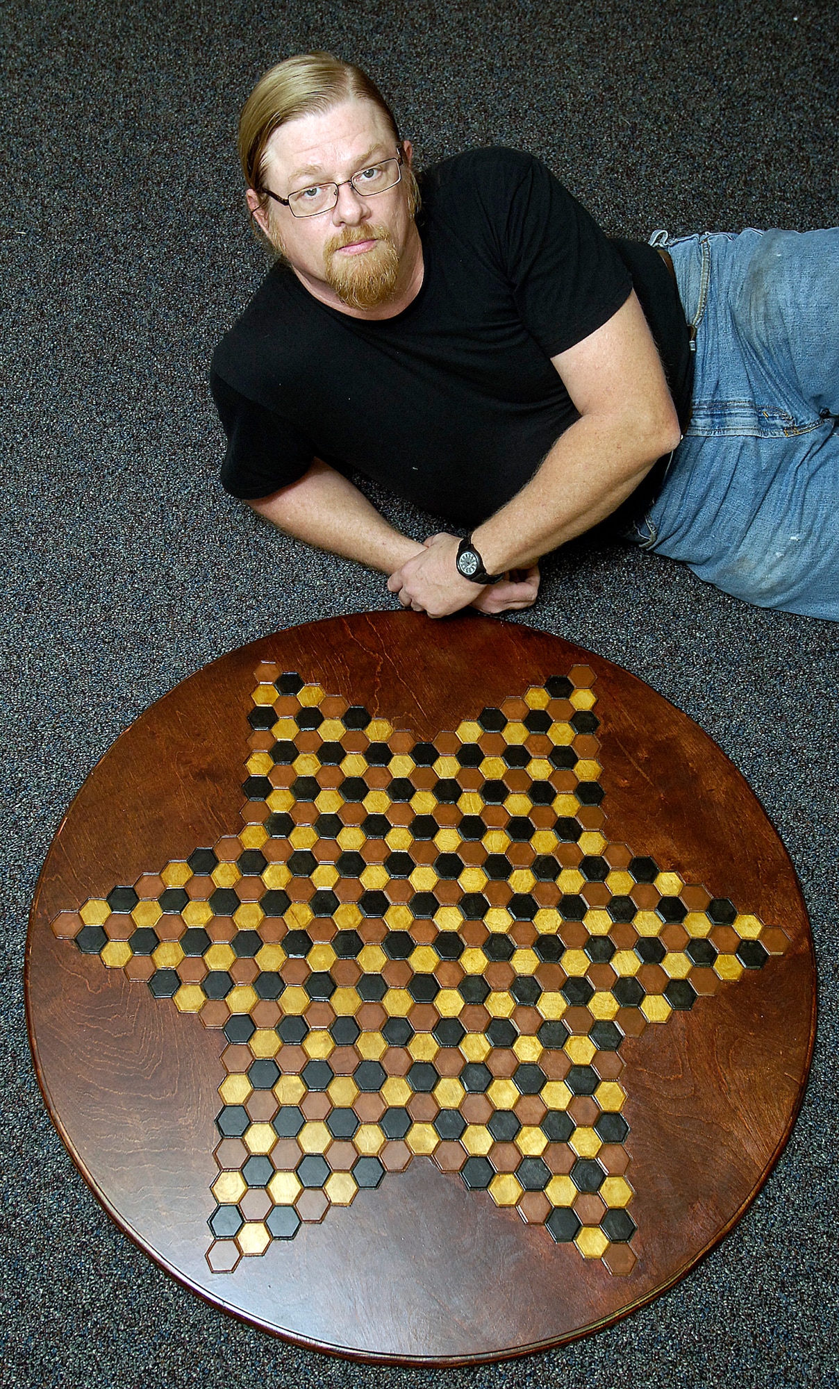 When not welding at Tinker, Mike Owen thinks chess. His idea that more than two could play the same chess game evolved and now waits for attorneys to patent his dream. His large, hand-made wooden gameboard accommodates six players. (Air Force photo by Margo Wright)