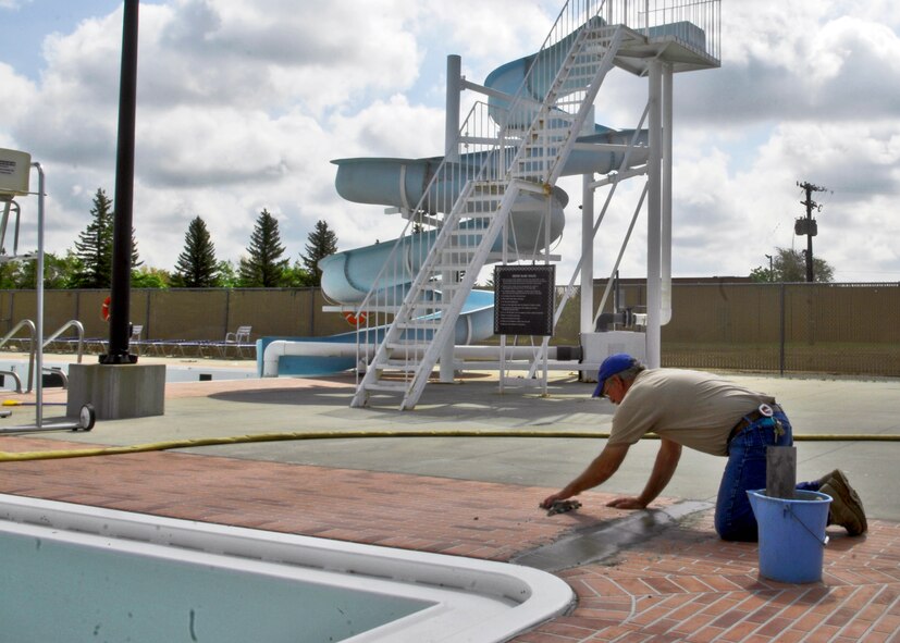 MINOT AIR FORCE BASE, ND --A contractor does some masonry work at the base pool here June 17.  The base pool and parking lot is  getting an overhaul in preparation for the opening of the pool. The pool opening date has yet to be determined.  (U.S. Air Force Photo by Staff Sgt. Miguel Lara)