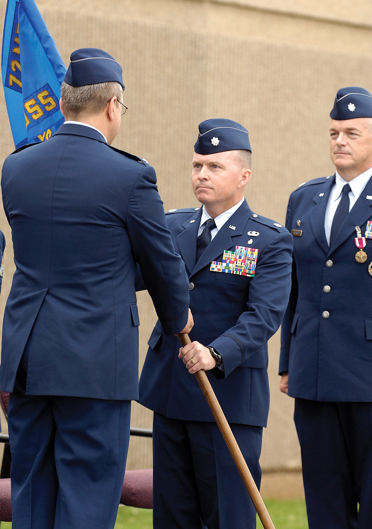 Lt. Col. Timothy Dykens accepts the 72nd Medical Support Squadron’s guidon from Col. Robert Marks during a June 12 change of command ceremony at the 72nd Medical Group facility. (Air Force photo by Margo Wright)