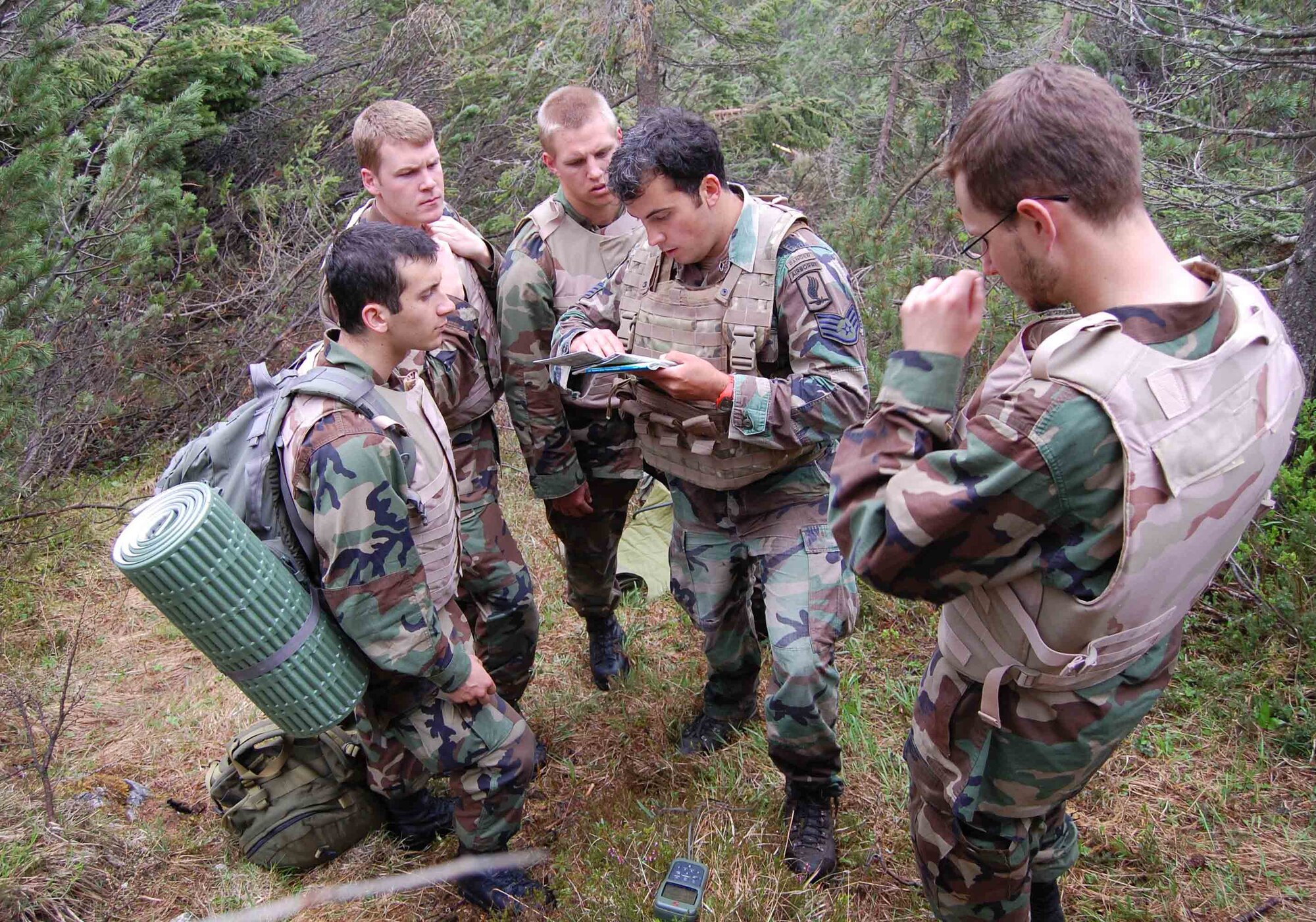 Staff Sgt. Gregory Predmore of the 8th Air Support Operations Squadron instructs Air Force Academy cadets in land navigation as part of an exercise in conjunction with the cadets' Operation Air Force visit to the base June 11. (U.S. Air Force photo/Staff Sgt. Lindsey Maurice)