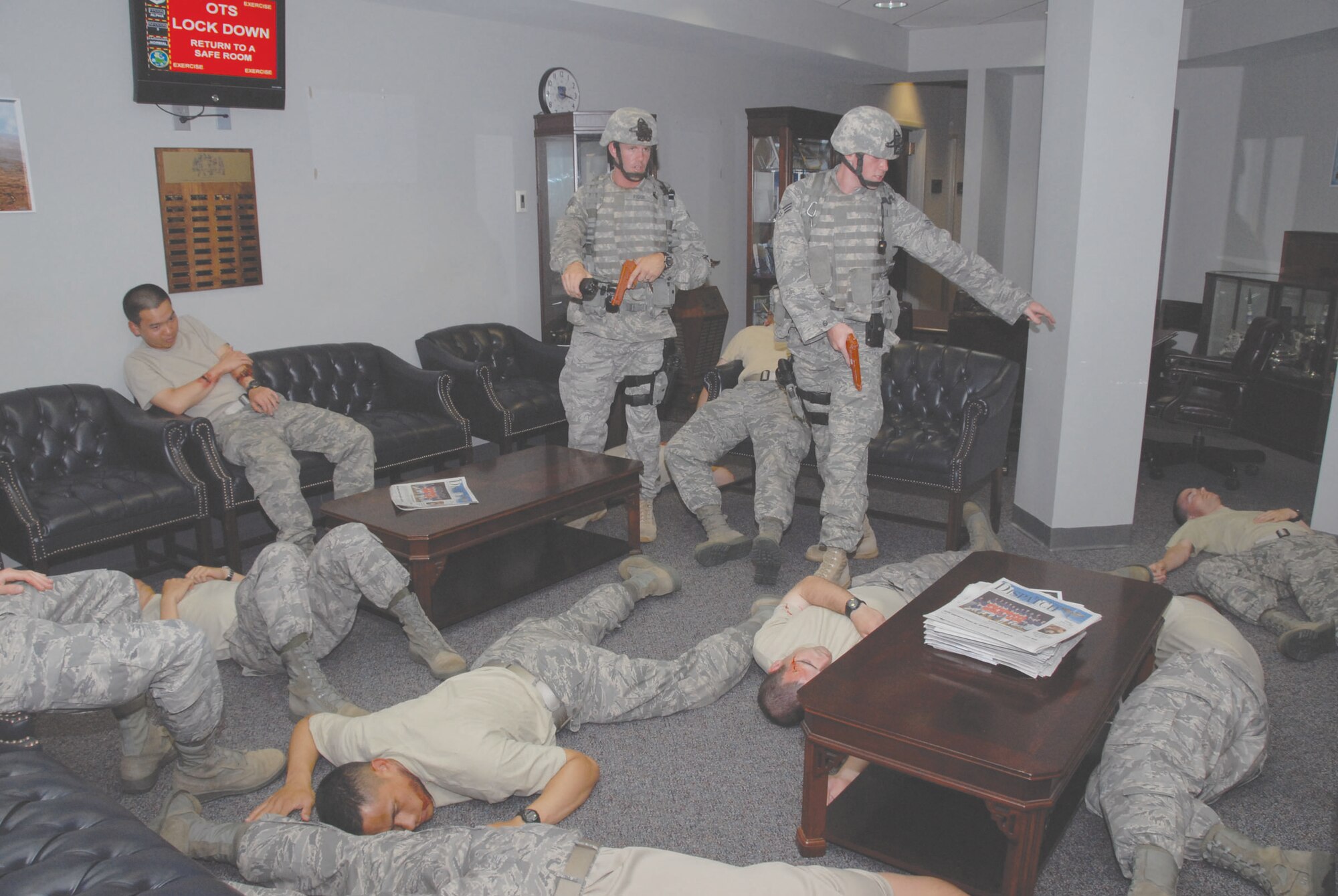 During the June Maxwell-Gunter exercise Officer Training School shooting scenario, 42nd Security Forces Squadron members enter a break area of the school to find mass casualties. In all, 12 OTS students, a bystander and the distraught gunman died in the exercise that involved a grudge against a student at OTS. (U.S. Air Force photo/Jamie Pitcher)
