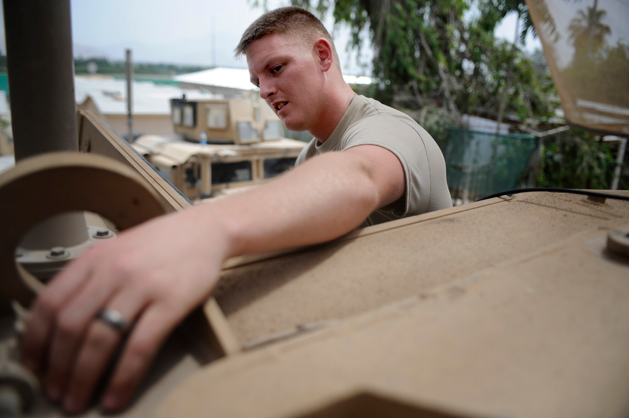 Staff Sgt. Andrew Palmer, Telephone Maintenance Specialist, Nangarhar Provincial Reconstruction Team, performs routine maintenance on a Mine Resistant Ambush Protected Vehicle May 30, 2009, at Forward Operating Base Fenley-Shields, Afghanistan. The PRT is responsible for development and reconstruction projects in Nangarhar Province. The projects are built by local contractors and are designed to improve the livelihood of the people living in the area. Newman is deployed from the 6th Communications Squadron, MacDill Air Force Base, Fla.  (U.S. Air Force Photo by Staff. Sgt. Shawn Weismiller)