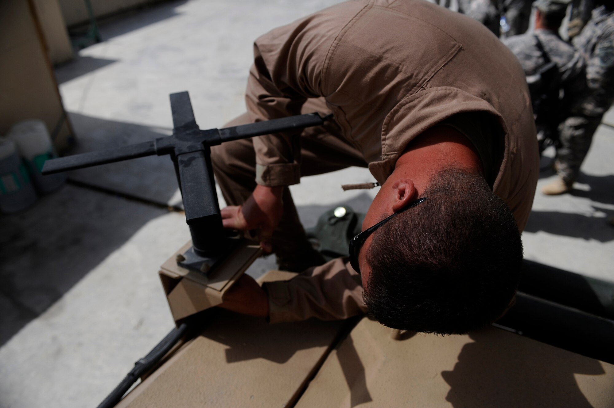 Staff Sgt. Josh Newman, Satellite Systems Specialist, Nangarhar Provincial Reconstruction Team, performs routine maintenance on a Mine Resistant Ambush Protected Vehicle May 30, 2009, at Forward Operating Base Fenley-Shields, Afghanistan. The PRT is responsible for development and reconstruction projects in Nangarhar Province. The projects are built by local contractors and are designed to improve the livelihood of the people living in the area. Newman is deployed from the 6th Communications Squadron, MacDill Air Force Base, Fla.  (U.S. Air Force Photo by Staff. Sgt. Shawn Weismiller)