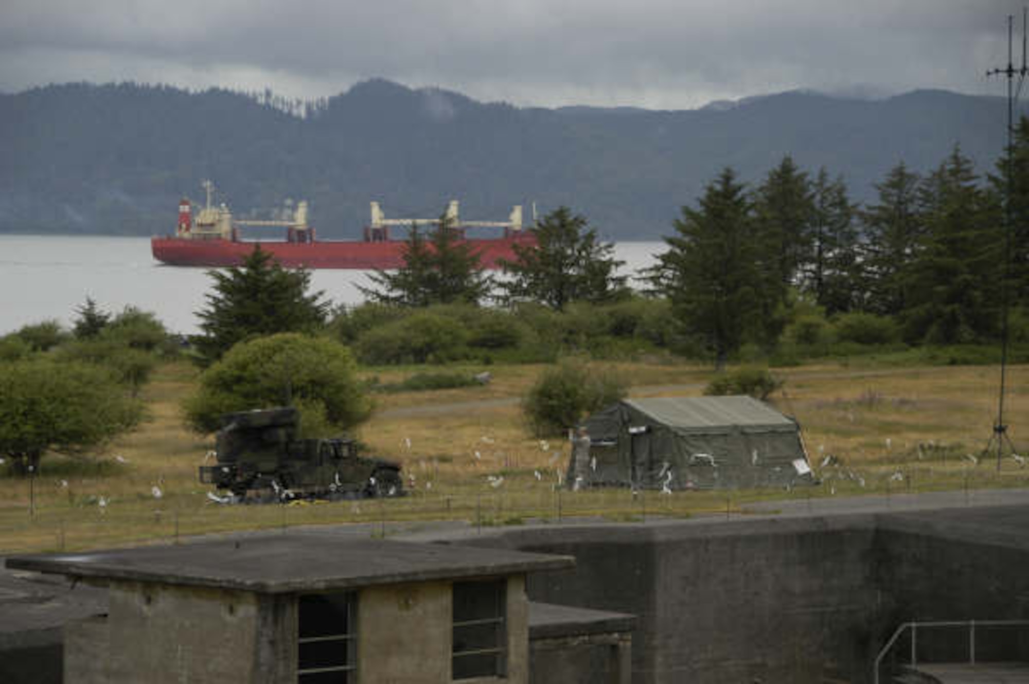 A soldier manning an Avenger missile defense system watches as a cargo ship travels down the Columbia River near historic Fort Stevens State Park. The historic old Army post located near Warrenton, Ore., constructed in the 19th century, is finding itself needed by 21st century warriors participating in a major U.S. Northern Command air defense exercise, Amalgam Dart 09, which began June 18. (U.S. Air Force photo by Al Eakle)
