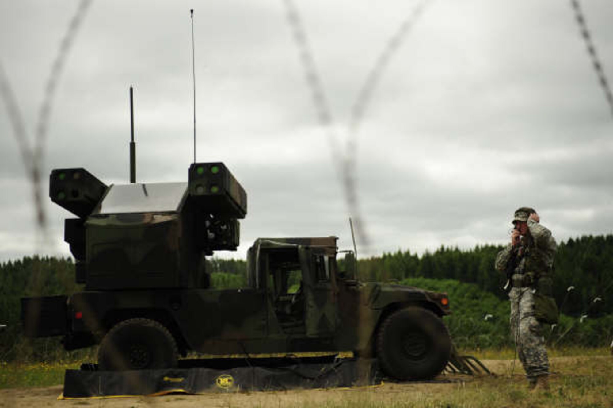 Sgt. Peter Williams from 2nd Battalion, 263rd Army Air Missile Defense Command, monitors radio traffic alongside an Avenger missile defense system during Amalgam Dart 2009 near Camp Rilea, Oregon, June 15. Amalgam Dart is a field test of the Department of Defense's ability to rapidly deploy a total air integrated defense system in the U.S. in order to deter, detect and defeat airborne threats. (U.S. Air Force photo by Staff Sgt. Jacob N. Bailey)

