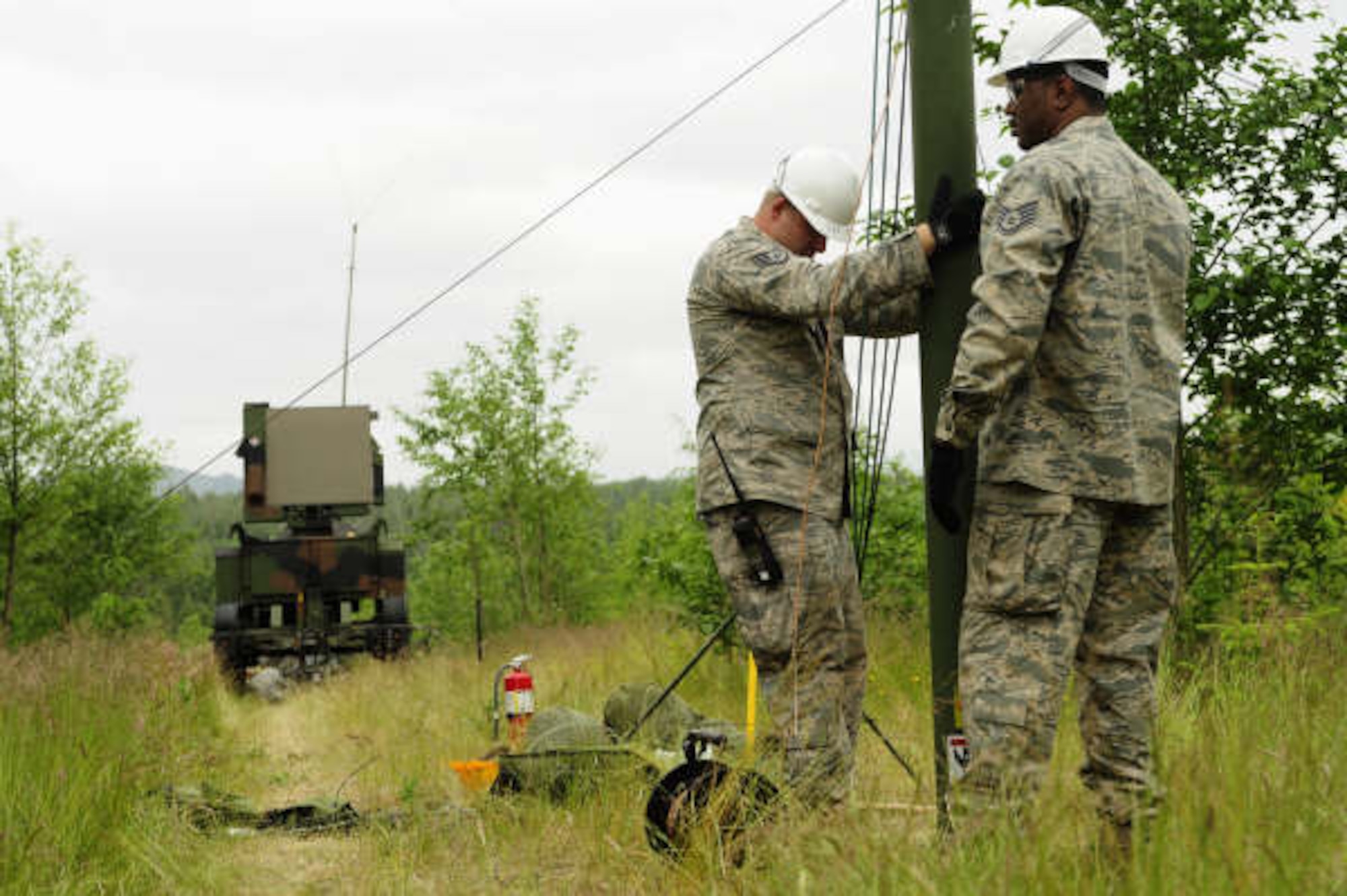 U. S. Air Force Staff Sgt. Anthony Johnson, Electronic Computer Systems Technician, and Staff Sgt. Ray Ouellette, Ground Radio Technician, set up an RF Module during Exercise Amalgam Dart, near Camp Rilea OR, June 14, 2009. (U.S. Air Force photo by Technical Sgt. Sean M. Worrell)