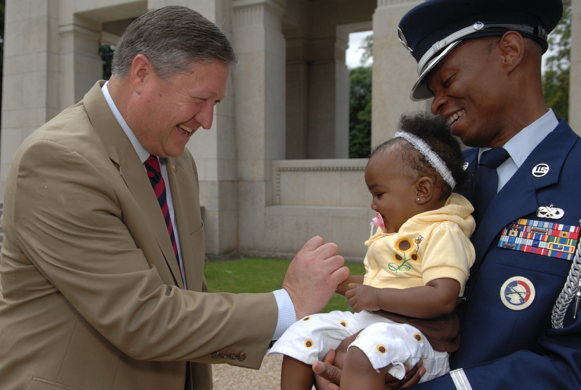 MARNES-LA-COQUETTE, France -- Secretary of the Air Force Michael B. Donley shakes the hand of Annesia Jackson, daughter of Tech. Sgt. Mike Jackson, member of the Spangdahlem Air Base Honor Guard in Germany.  Secretary Donley chatted and posed for photos after thanking the 52nd Honor Guard for their support at a wreath laying ceremony at the Memorial de l’Escadrille La Fayette outside of Paris June 13.  (U.S. Air Force photo by Master Sgt. Bill Gomez)