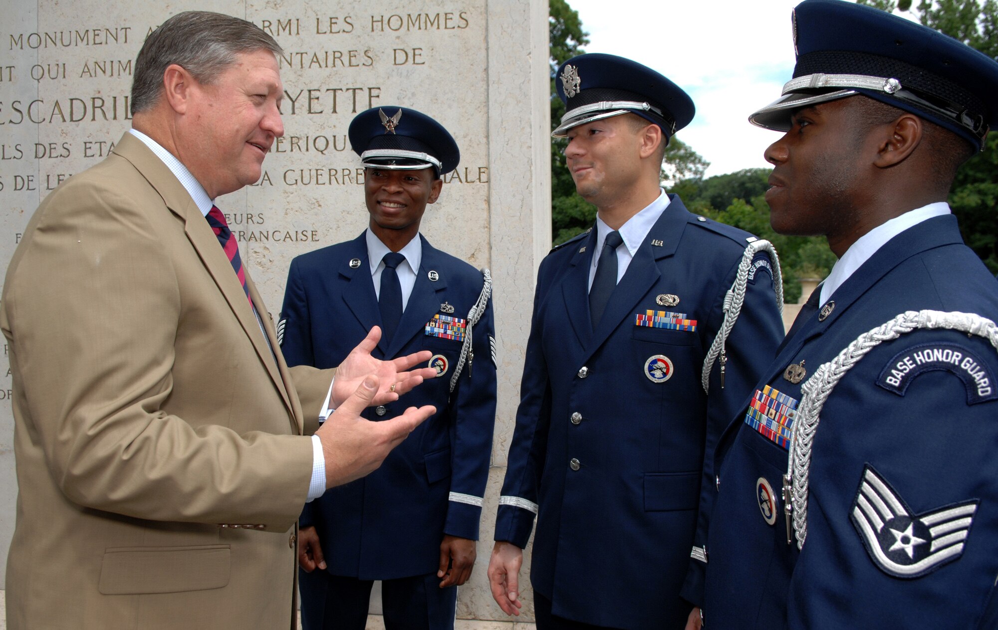 MARNES-LA-COQUETTE, France -- Secretary of the Air Force Michael B. Donley praises Tech. Sgt. Mike Jackson, 1st Lt. Chris McDaniels and Staff Sgt. Fred Stevenson, members of the Spangdahlem Air Base Honor Guard in Germany, for their support in a wreath laying ceremony at the Memorial de l’Escadrille La Fayette outside of Paris June 13.  The ceremony was attended by U.S. senators, the Secretary of the Air Force, and U.S. and French dignitaries. It paid honor to American volunteer combat flying aces,the Lafayette Escadrille, who flew under the French flag during World War I. (U.S. Air Force photo by Master Sgt. Bill Gomez)