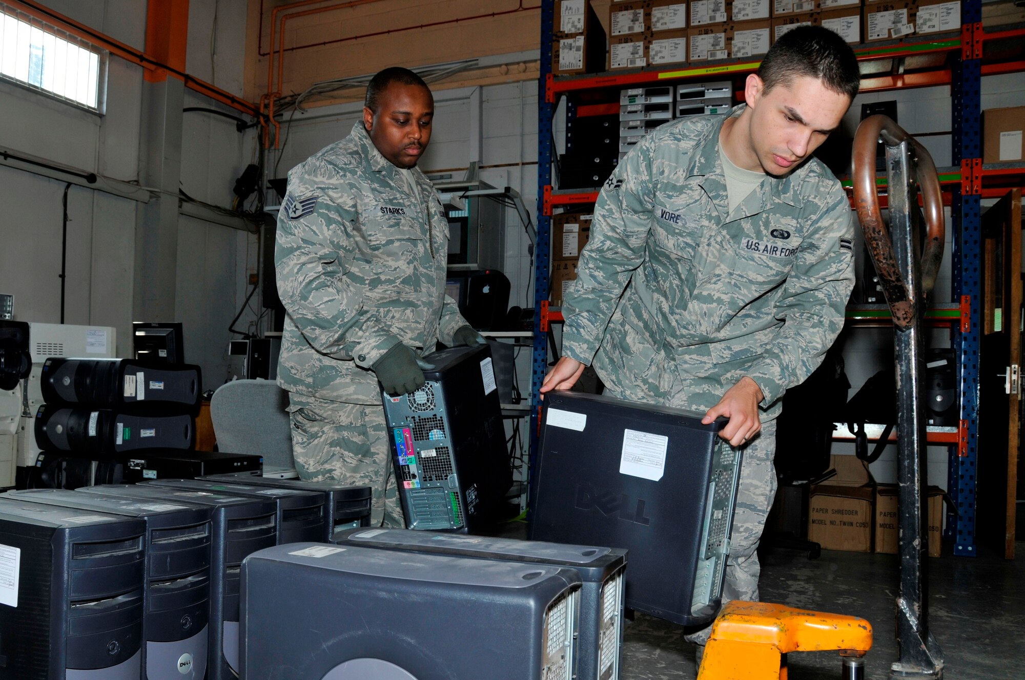 Airman 1st Class Cody Vore and Staff Sgt. Leo Starks, 48th Communication Squadron Asset Management, move computers onto a pallet June 16, 2009 at RAF Lakenheath, England. The computers will be sent to the Defense Reutilization and Marketing Service Center. The DRMO Center will reuse, donate, sell or dispose of the computers. (U.S. Air Force photo by Airman 1st Class Perry Aston) 