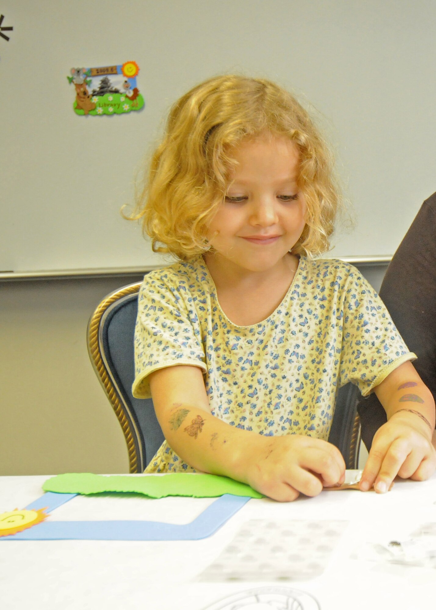YOKOTA AIR BASE, Japan -- Matilda Glapion decorates a picture frame during an Australian-themed craft day at the base library's summer reading program June 18. Each year the Air Force conducts a summer reading program for children of military members to help improve their reading proficiency. This year's theme is Book-A-Trip: Read Around the World. (U.S. Air Force photo/Staff Sgt. Veronica Pierce)