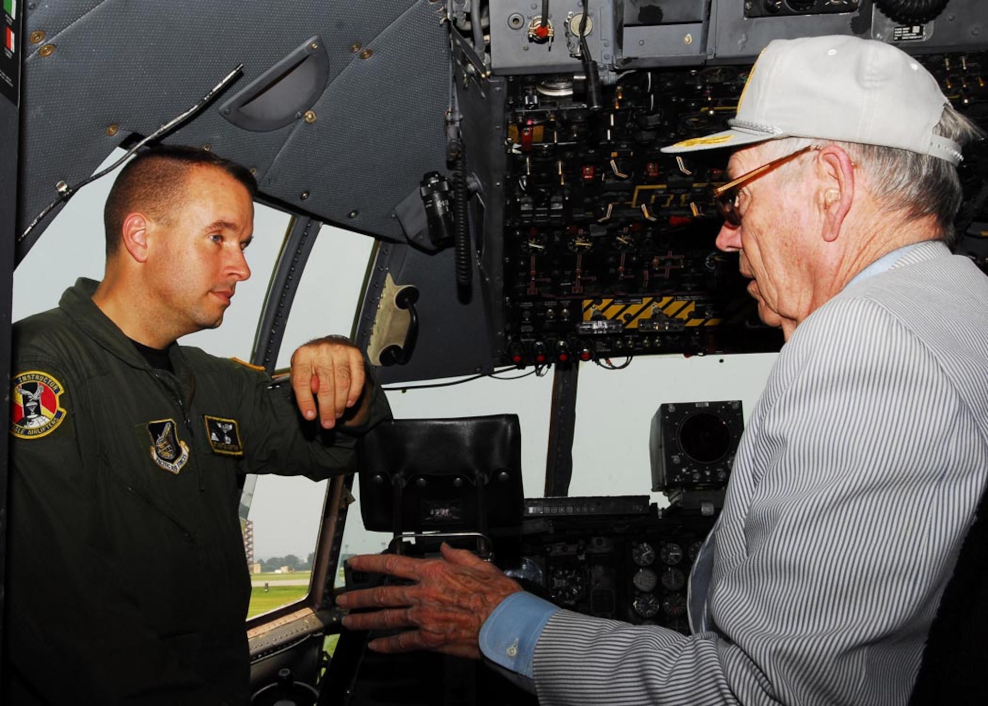 YOKOTA AIR BASE, Japan -- Technical Sgt. Hunter Compton, 36th Airlift Squadron flight engineer, talks with Ric Lessey, during the Defense Orientation Conference Association tour June 19. DOCA provides a means of continuing education for its members in matters pertaining to national security under the jurisdiction and supervision of the Department of Defense and State. The purpose of the tour was for members to obtain an understanding of the 374th Airlift Wing mission. (U.S. Air Force photo/Airman Sean Martin)