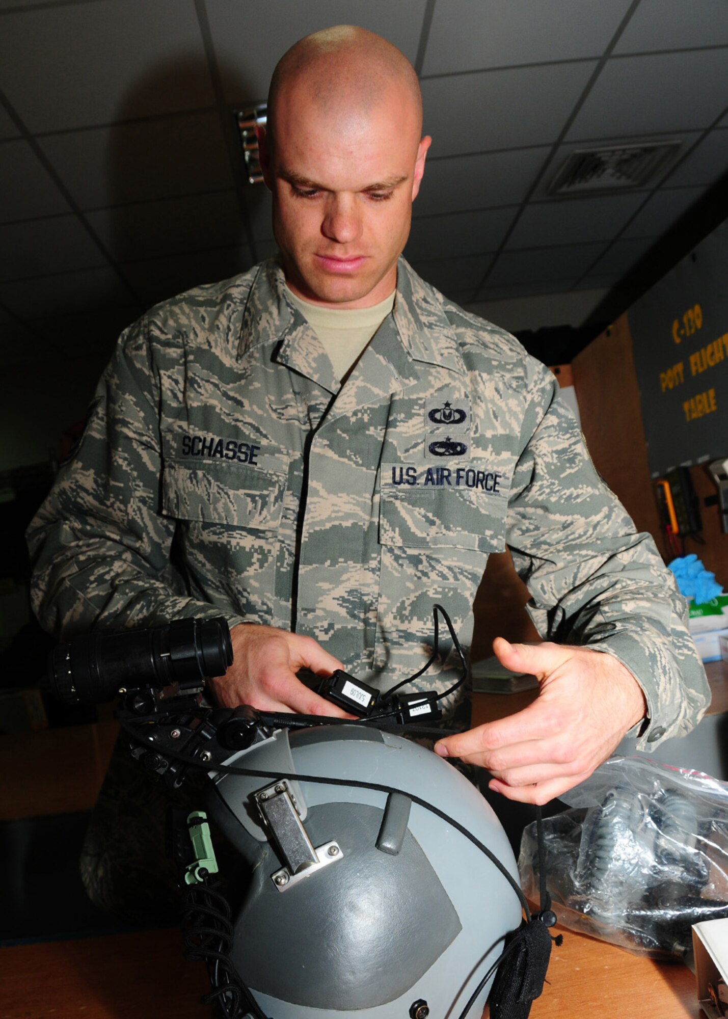 SOUTHWEST ASIA -- Tech. Sgt. Nathan Schasse, 817th Expeditionary Airlift Squadron, checks the overall fit of the night vision goggle and battery pack to the helmet at an air base in Southwest Asia, June 18. Sergeant Schasse also checks to make sure that there is no damage to the battery pack and ensures the pack is secure on the low-profile mount. Sergeant Schasse is deployed from McChord Air Force Base, Wash., and is originally from Madison, Wis. (U.S. Air Force photo/Senior Airman Courtney Richardson)