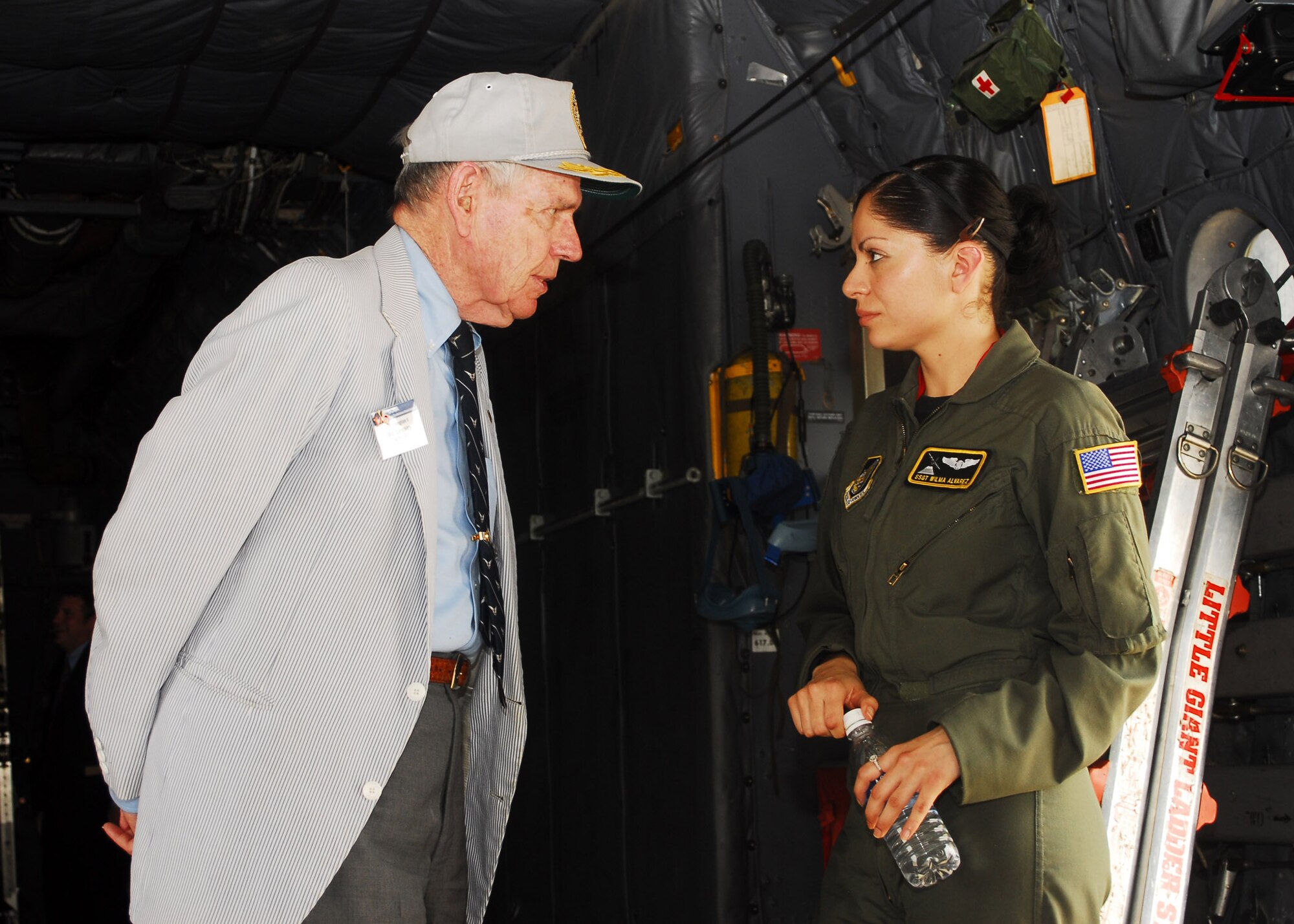 YOKOTA AIR Base, Japan -- Staff Sgt. Wilma Alvarez, 36th Airlift Squadron loadmaster, talks with Ric Lessey during the Defense Orientation Conference Association tour June 19. DOCA provides a means of continuing education for its members in matters pertaining to national security under the jurisdiction and supervision of the Department of Defense and State. The purpose of the tour was for the members to obtain an understanding of the 374th Airlift Wing mission. (U.S. Air Force photo/Airman Sean Martin)