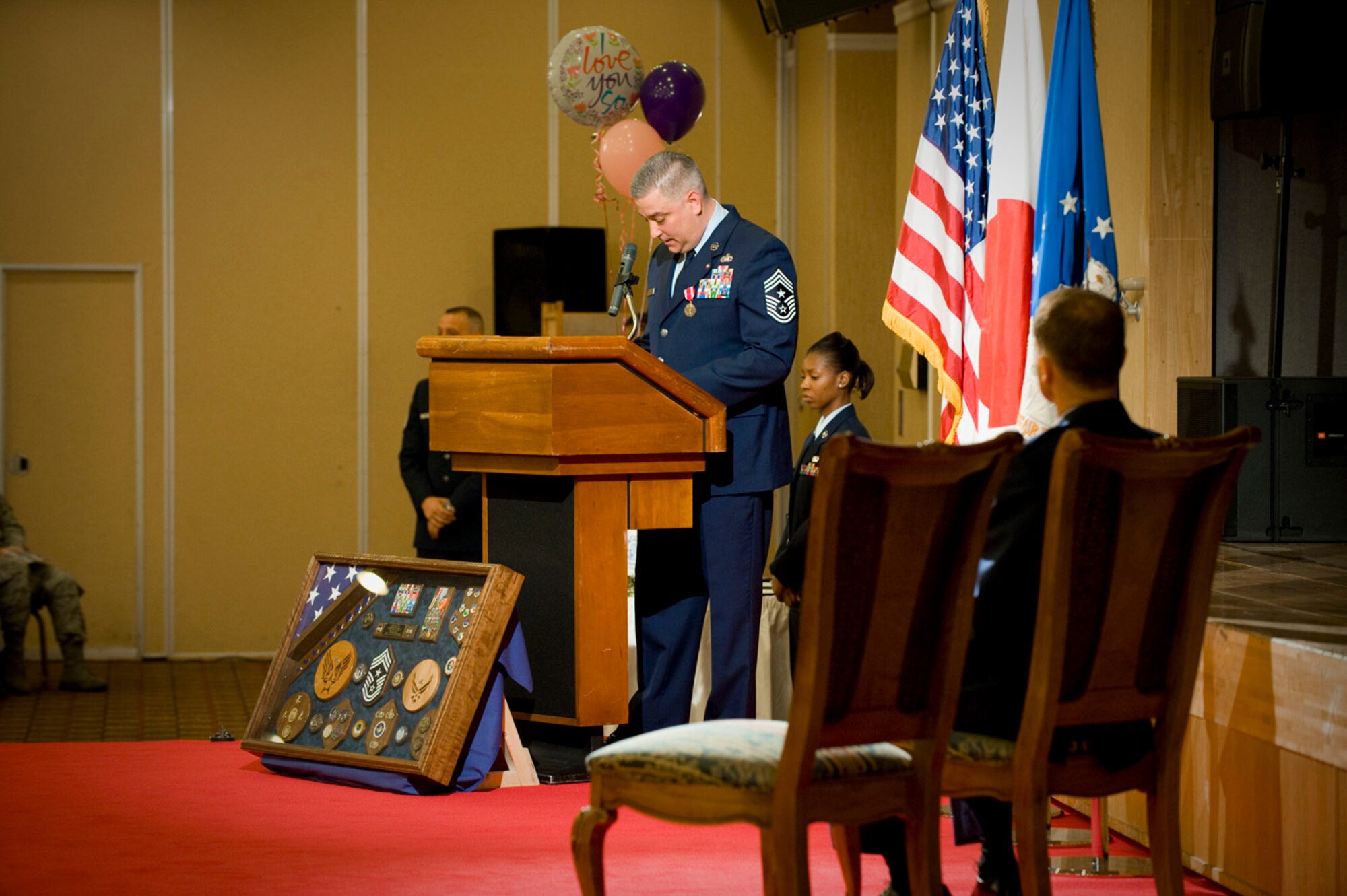 MISAWA AIR BASE, Japan -- Chief Master Sgt. Ricky Price reads an old birthday letter from his mother during his retirement speech June 19, 2009. Chief Price credited his parents for raising him to have the character he relied on throughout his military career. (U.S. Air Force photo by Staff Sgt. Samuel Morse)