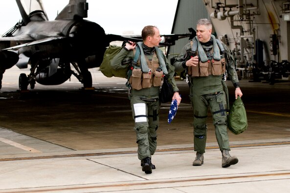 Col. David Stilwell, 35th Fighter Wing commander, and Chief Master Sgt. Ricky Price, 35th Fighter Wing command chief, head out after flying in an F-16 Fighting Falcon at Misawa Air Base, Japan, June 15, 2009. Colonel Stilwell gave Chief Price an incentive flight in the jet to thank him for his 25 years of service in the Air Force. (U.S. Air Force photo by Staff Sgt. Samuel Morse)
