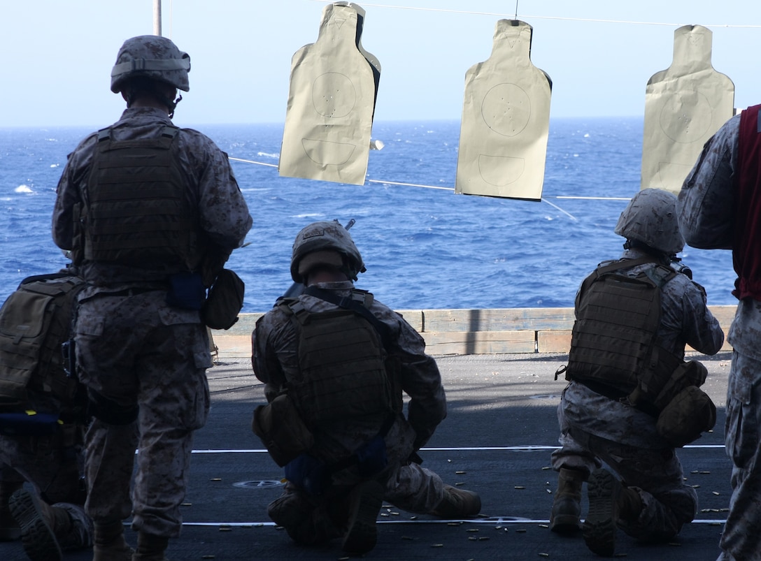 Marines with Combined Anti-Armor Team, Battalion Landing Team, 3rd Battalion, 2nd Marine Regiment, 22nd Marine Expeditionary Unit, perform tactical magazine reloads aboard USS Bataan during a small arms live-fire shoot June 19, 2009. Marines shot at close static targets to keep their marksmanship skills sharp while aboard the ship. The 22nd MEU is currently on a scheduled seven-month deployment.