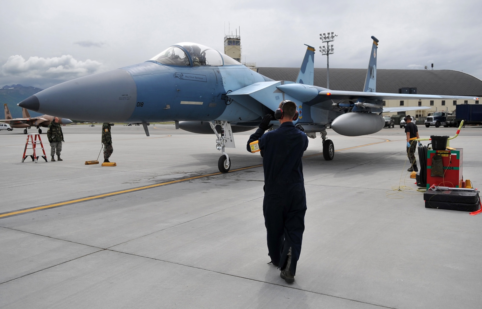 090618-F-2034C-057
Airman 1st Class Matt Alvarado marshals an F-15C Eagle to its parking spots June 18, 2009 during Exercise Northern Edge 09 held at Elmendorf Air Force Base, Alaska. A1C Alvarado is a crew chief from the 57th Aircraft Maintenance Squadron, Nellis AFB. Northern Edge is Alaska?s largest military training exercise that prepares joint forces to respond to crises throughout the Asia-Pacific region. (U.S. Air Force photo/ MSgt Shane A. Cuomo) RELEASED
